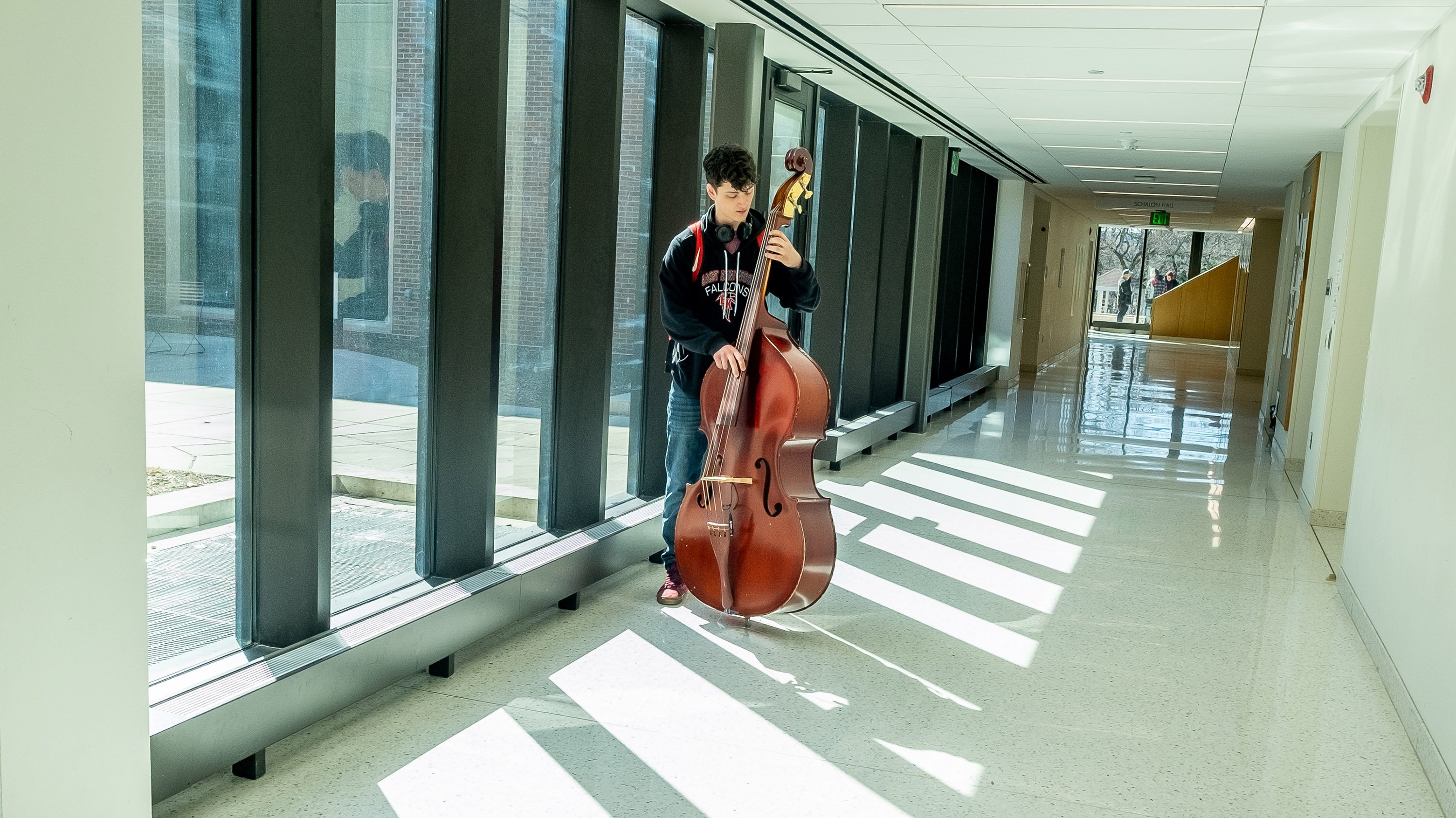 MSU Music major Judah Guerra plays his bass in the hallway of the Billman Music Building