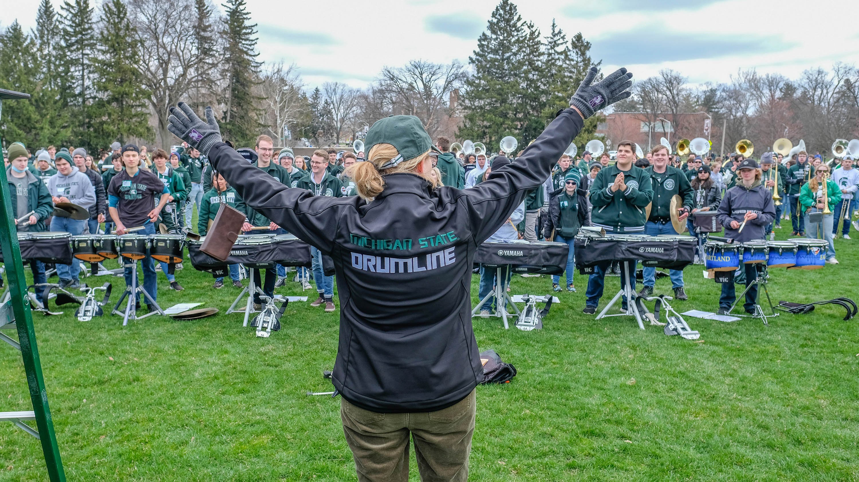 Provost Teresa K. Woodruff in front of the MSU Drumline