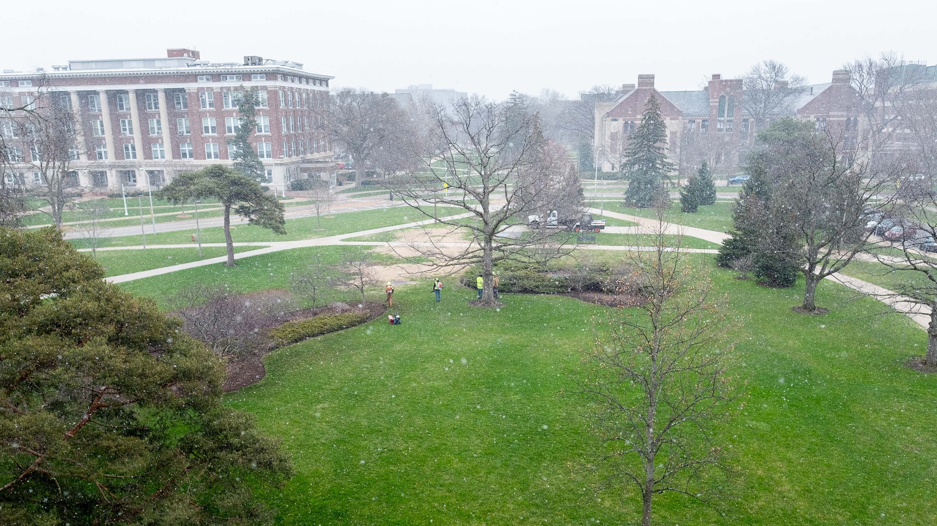Birds-eye view of Landscape Services crew working on a snowy spring morning.