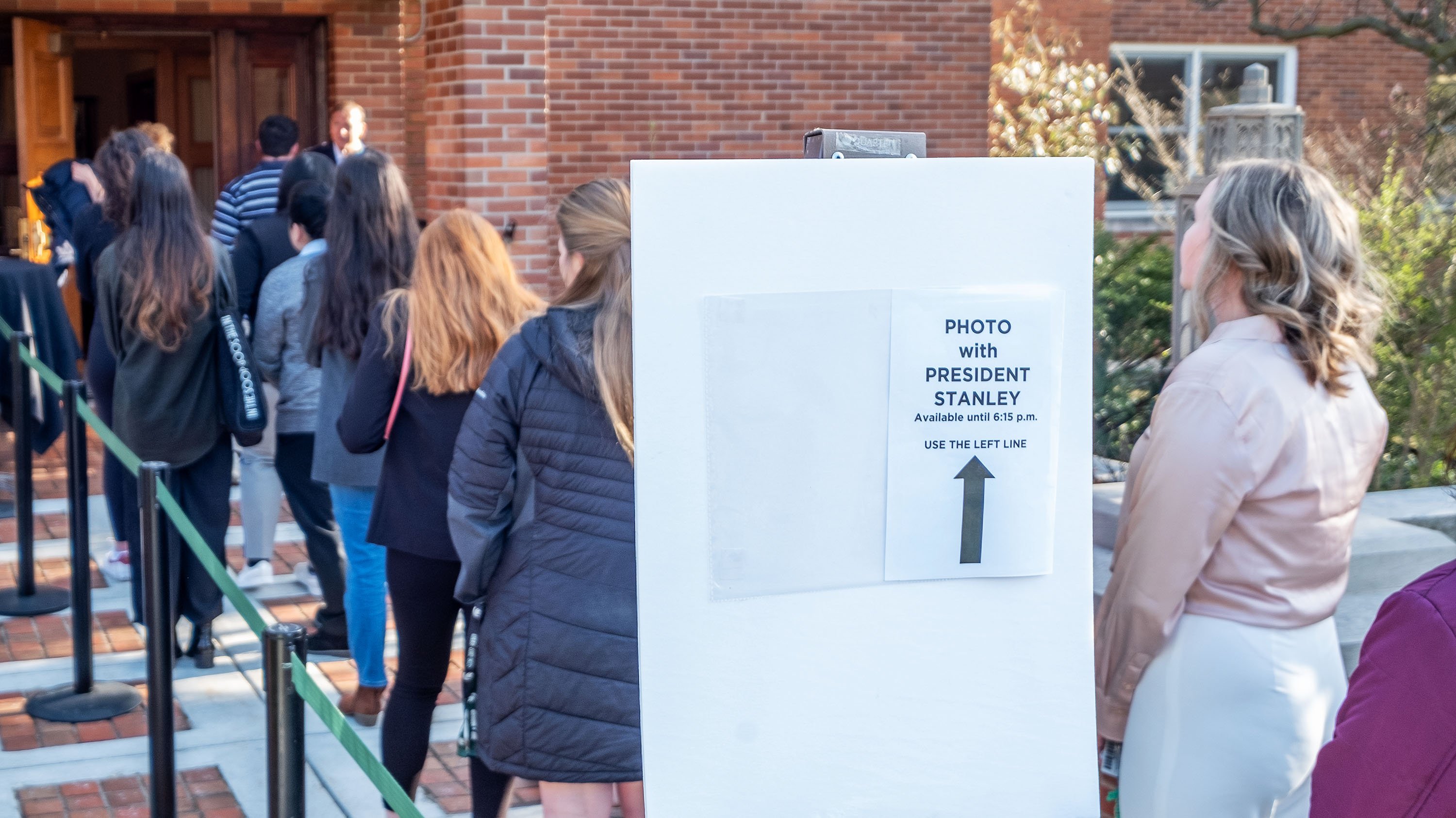Students lining up outside Cowles House for photo with President Stanley