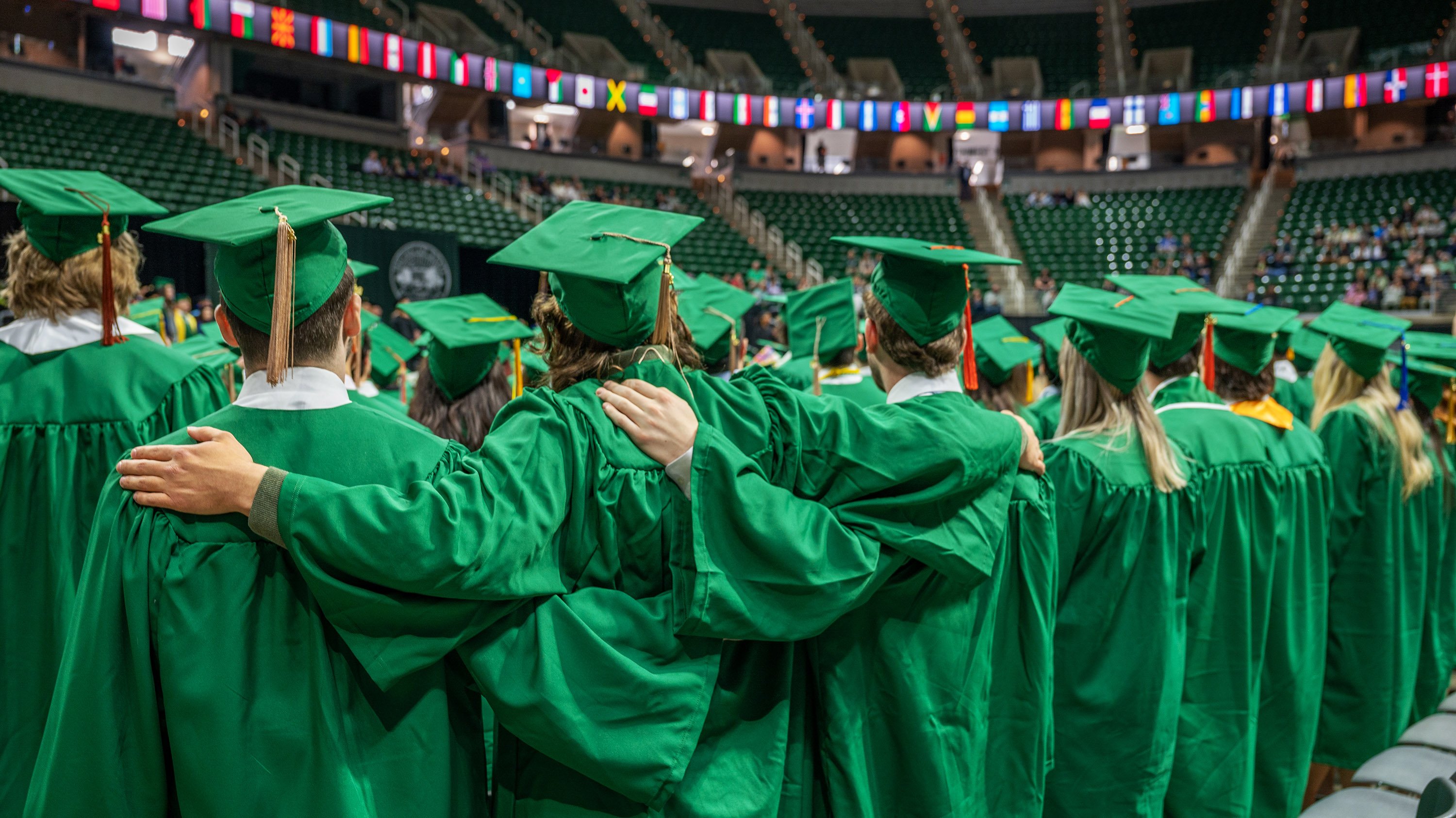 Three spring 2022 graduates join arms to sing the MSU alma mater