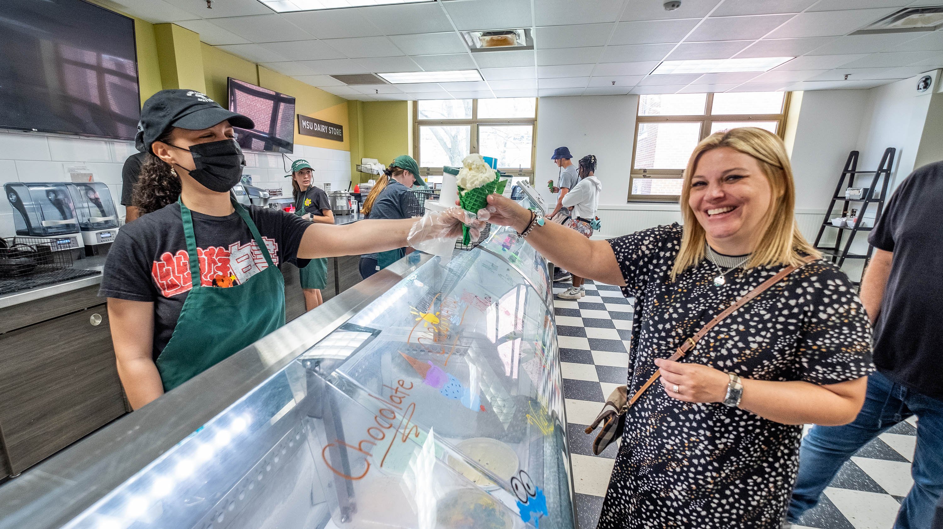 Woman receiving a cone of ice cream at the MSU Dairy Store