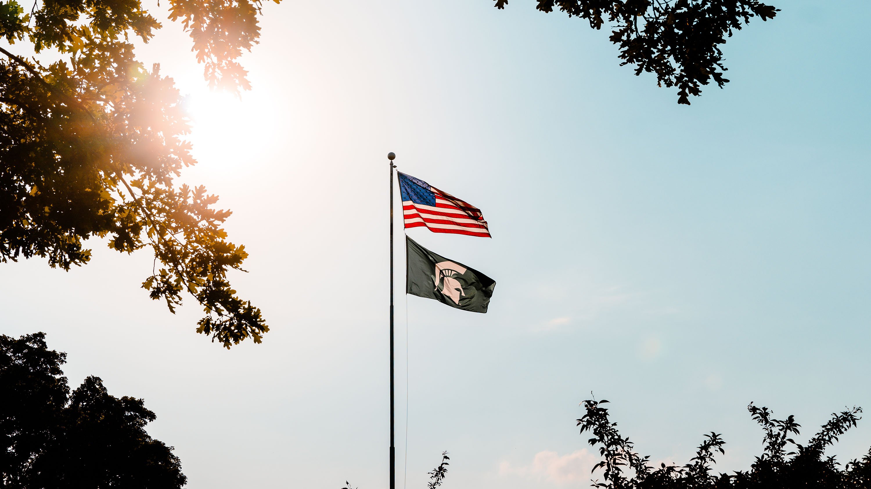 American and Spartan flags on flagpole