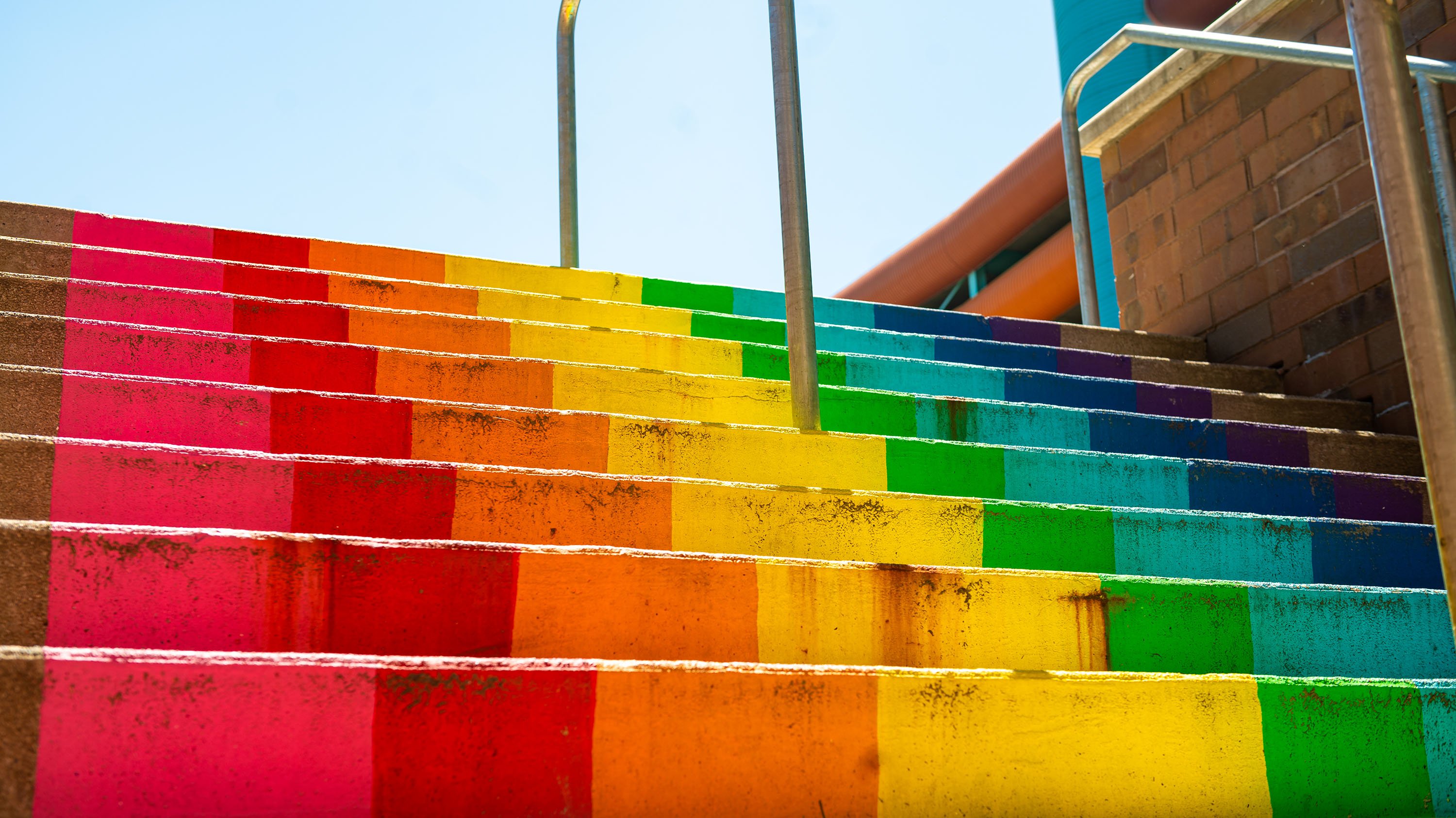 Outdoor stairs painted with rainbow pattern
