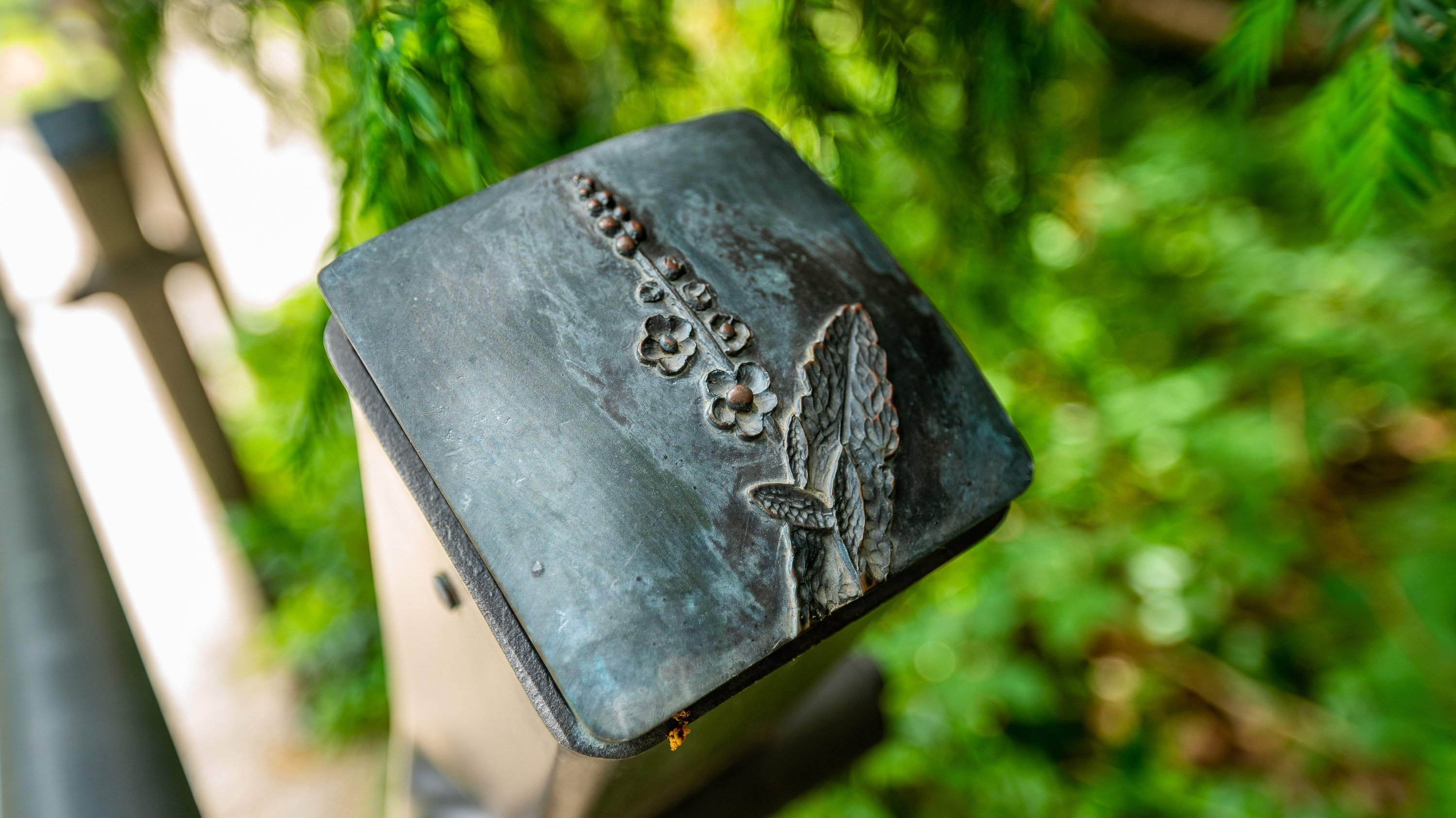 Close-up of a post cap in Beal Botanical garden, showing a relief of a mullein plant