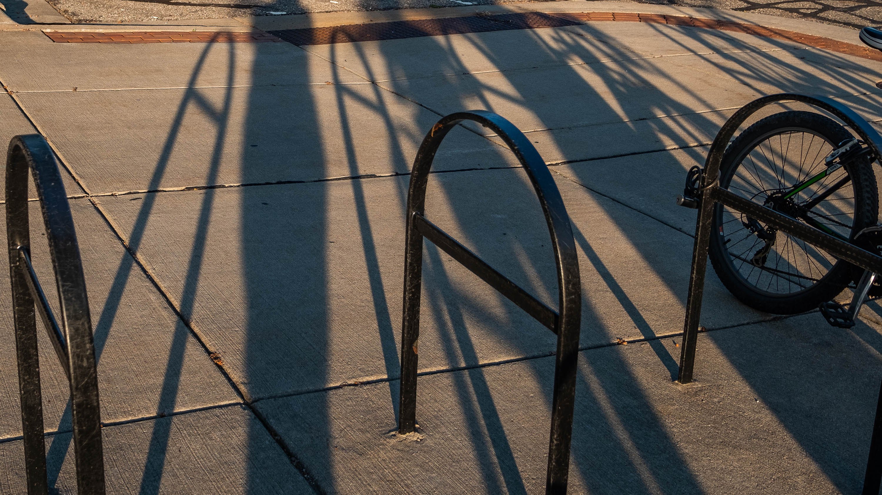 Bike racks with long shadows during sunset