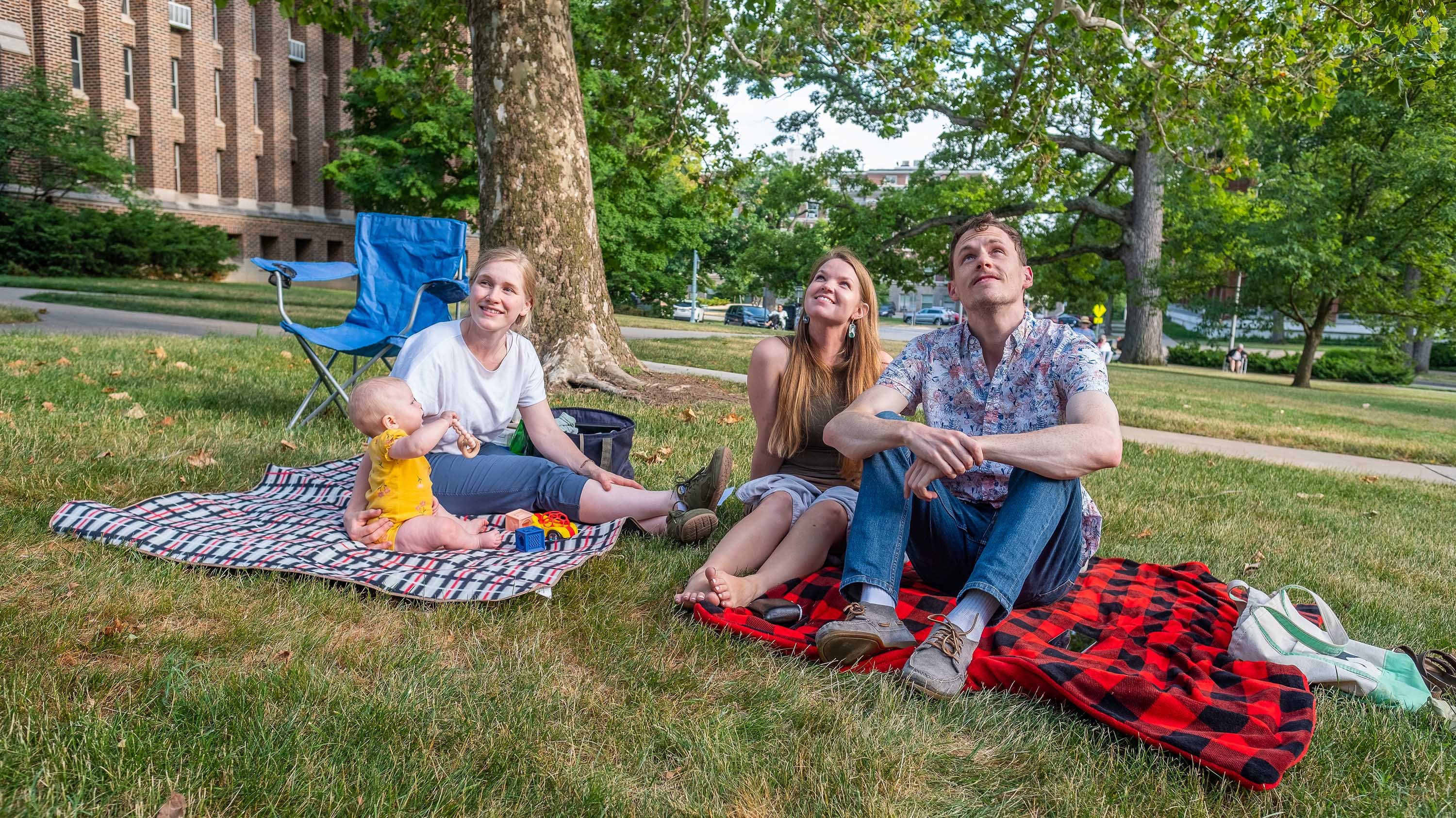 Family sitting on the ground watching carillon concert