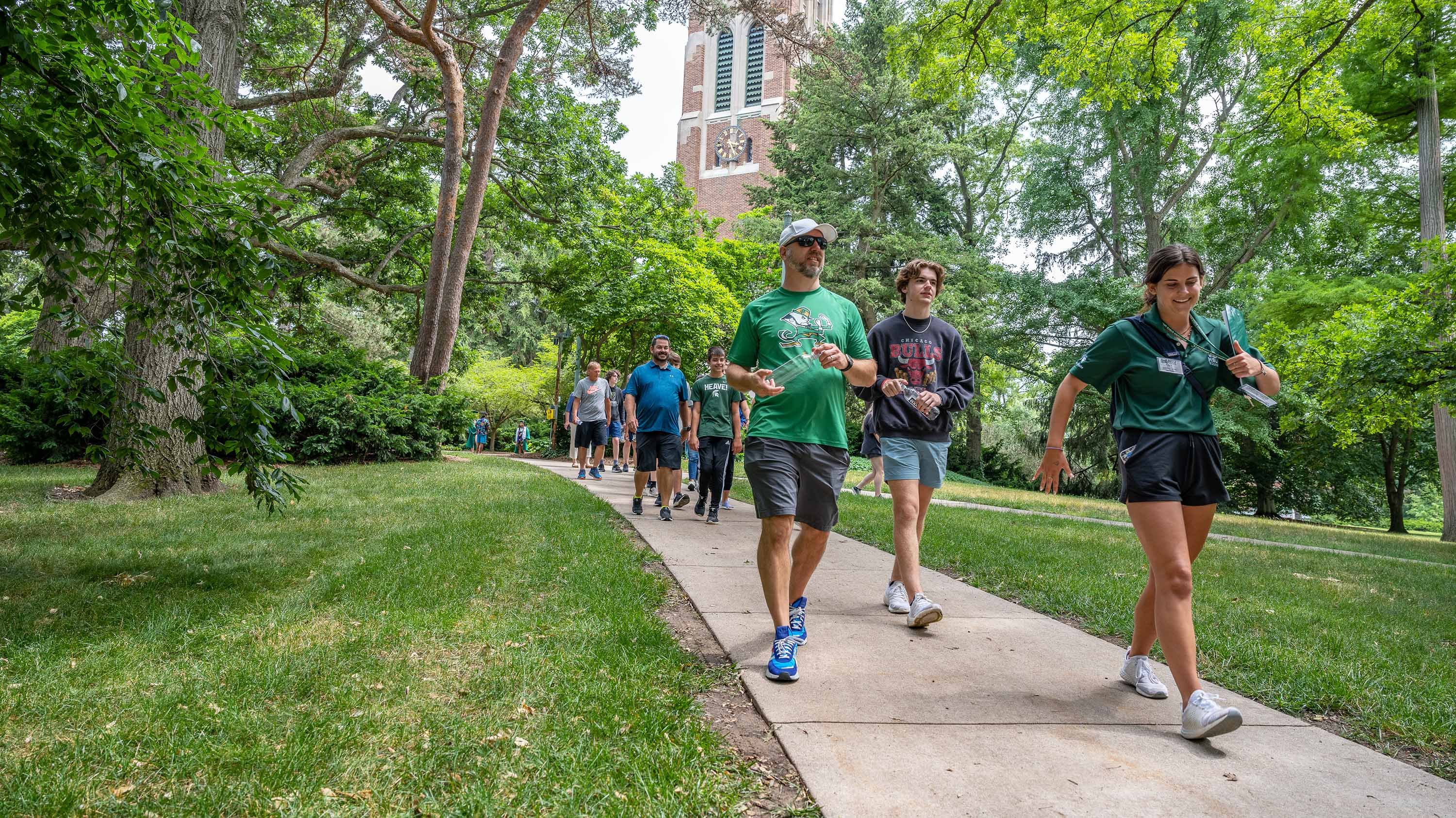 Student ambassador leading group on a campus tour near Beaumont Tower