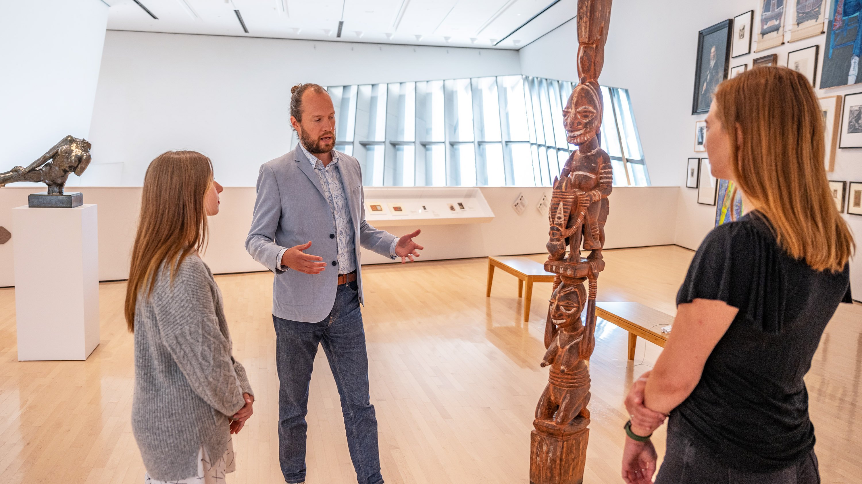 Steven Bridges talking about a wooden pole carving in the Broad Art Museum