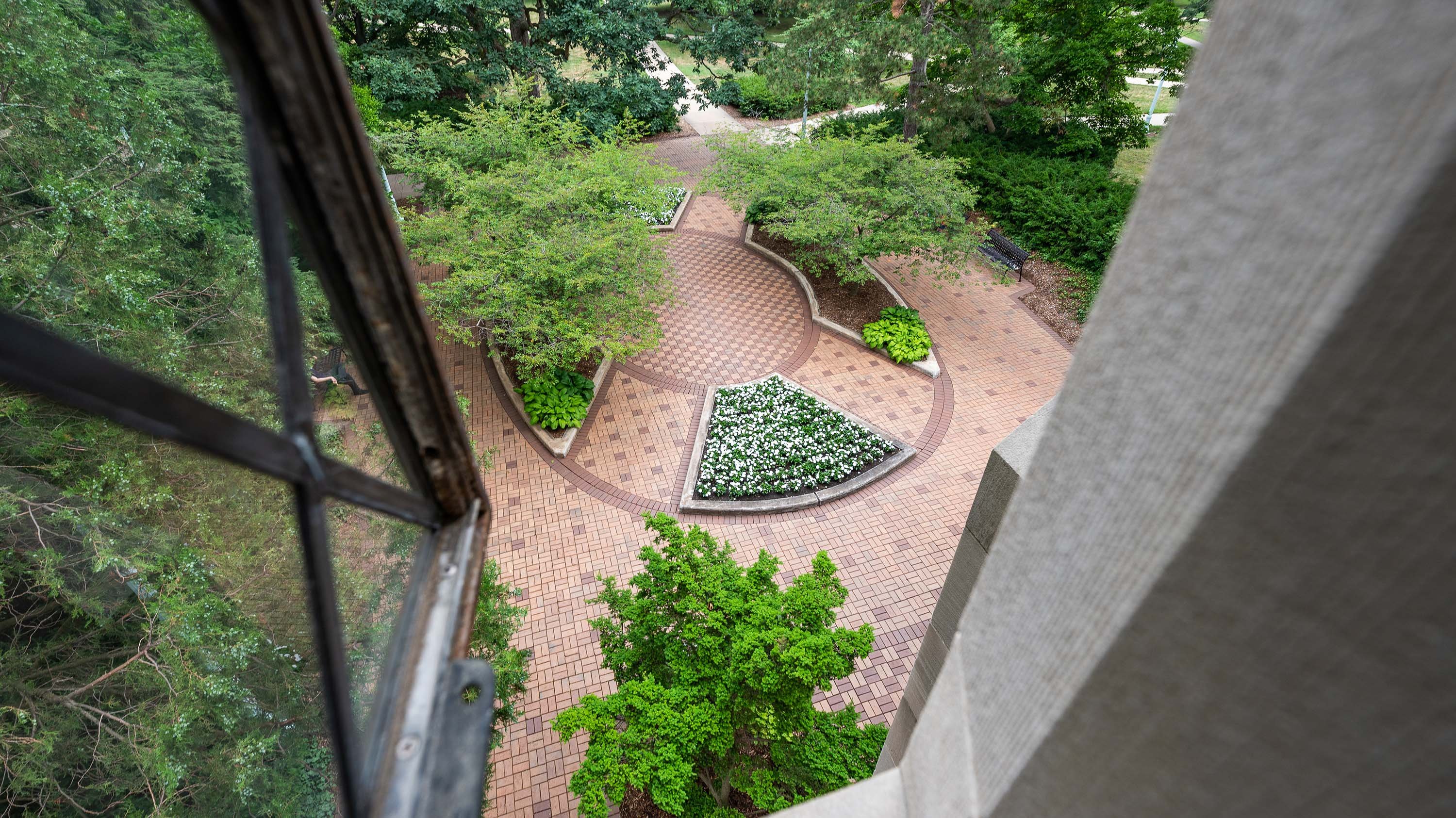 View of the plaza in front of Beaumont Tower, showing landscaped garden beds