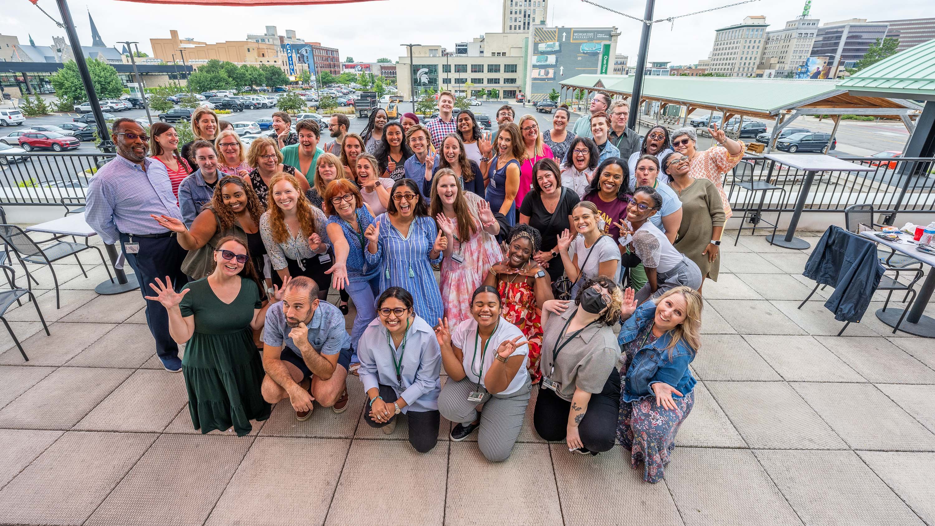 Members of the Flint Registry team posing together on a patio in Flint