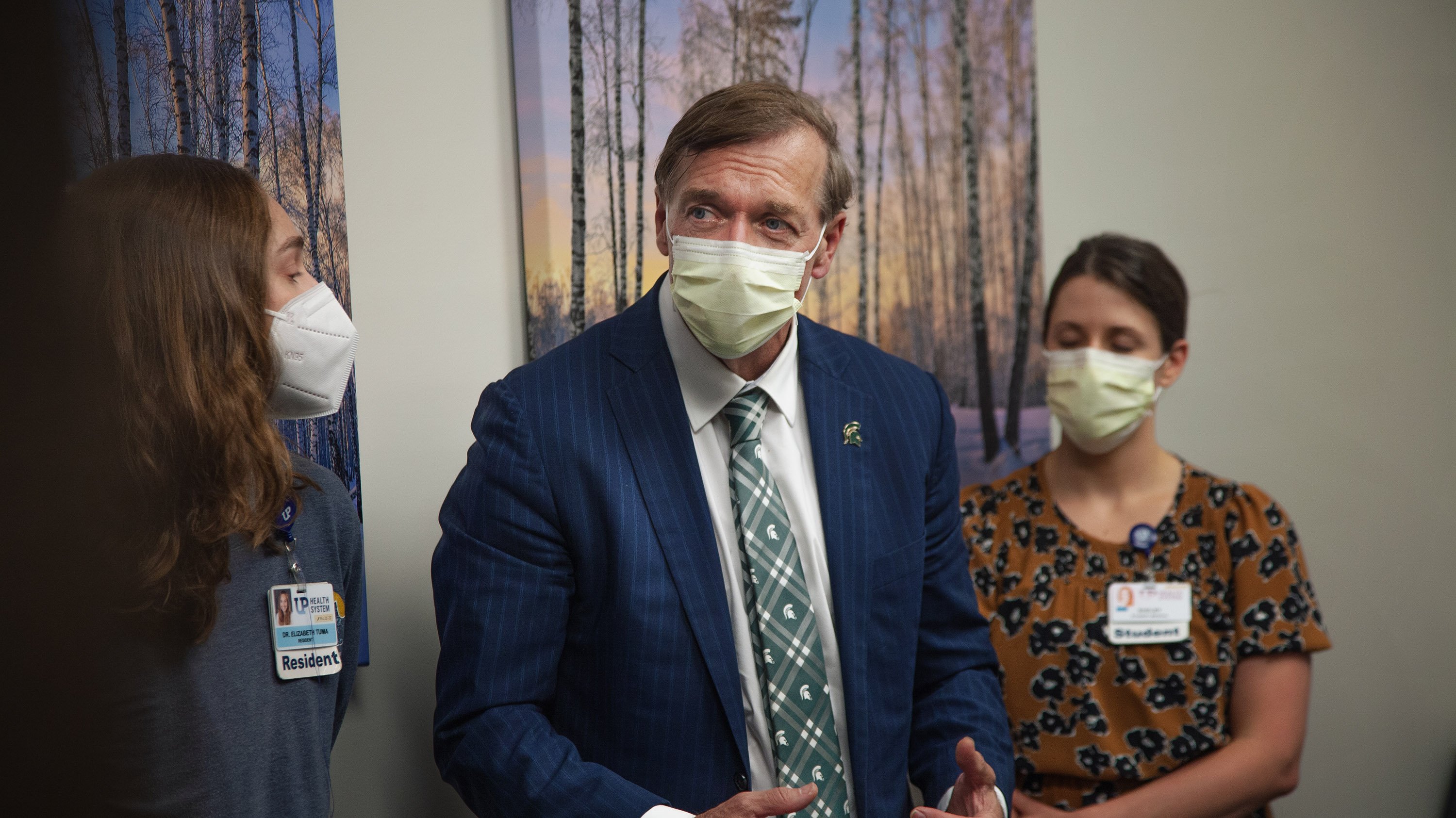 Medical resident Elizabeth Tuma and medical student Shelby Peters with the College of Human Medicine, UP Campus, speak with President Stanley during his visit.
