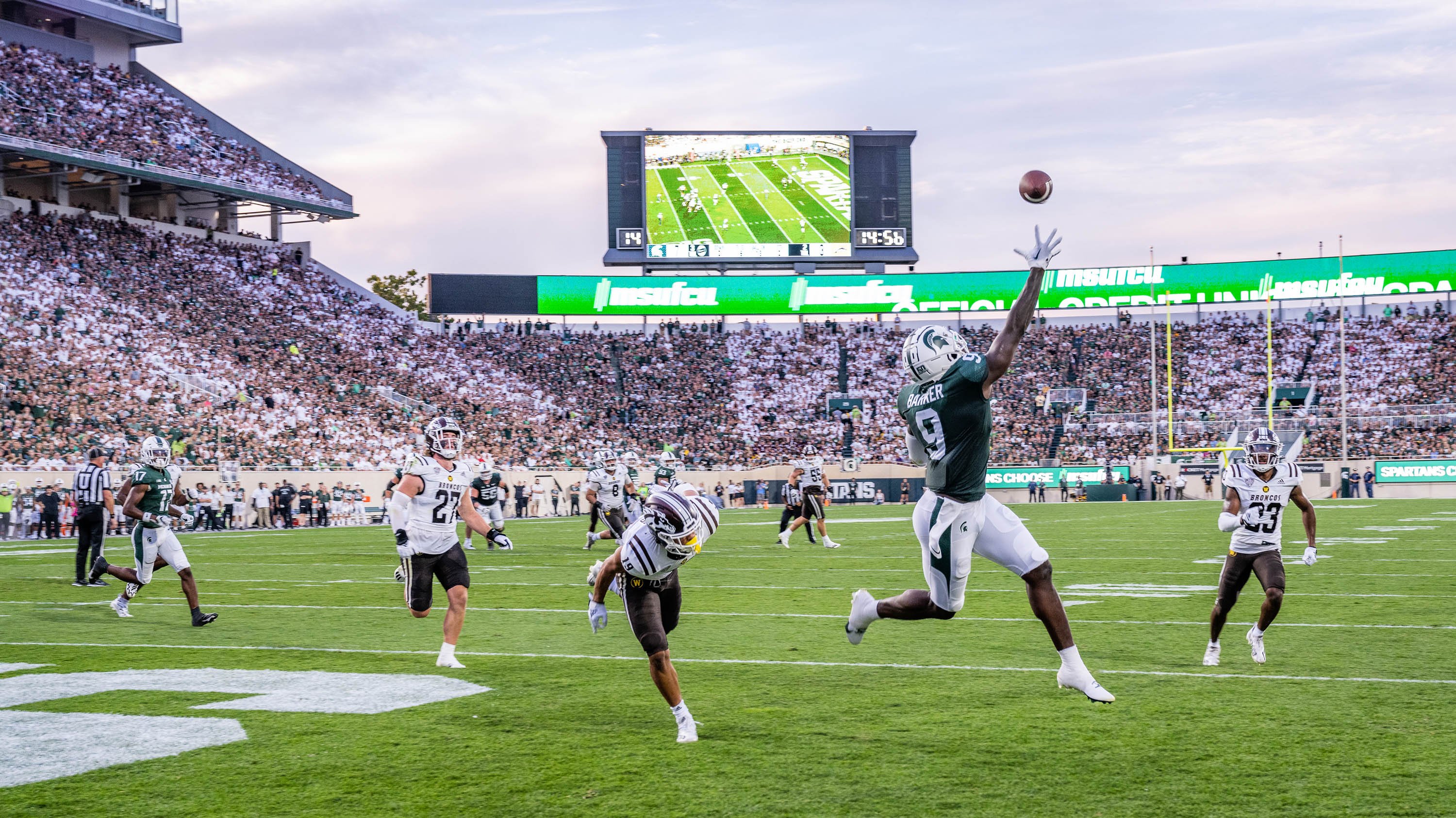 Spartan football player catches a touchdown pass at the MSU Spartan Football game