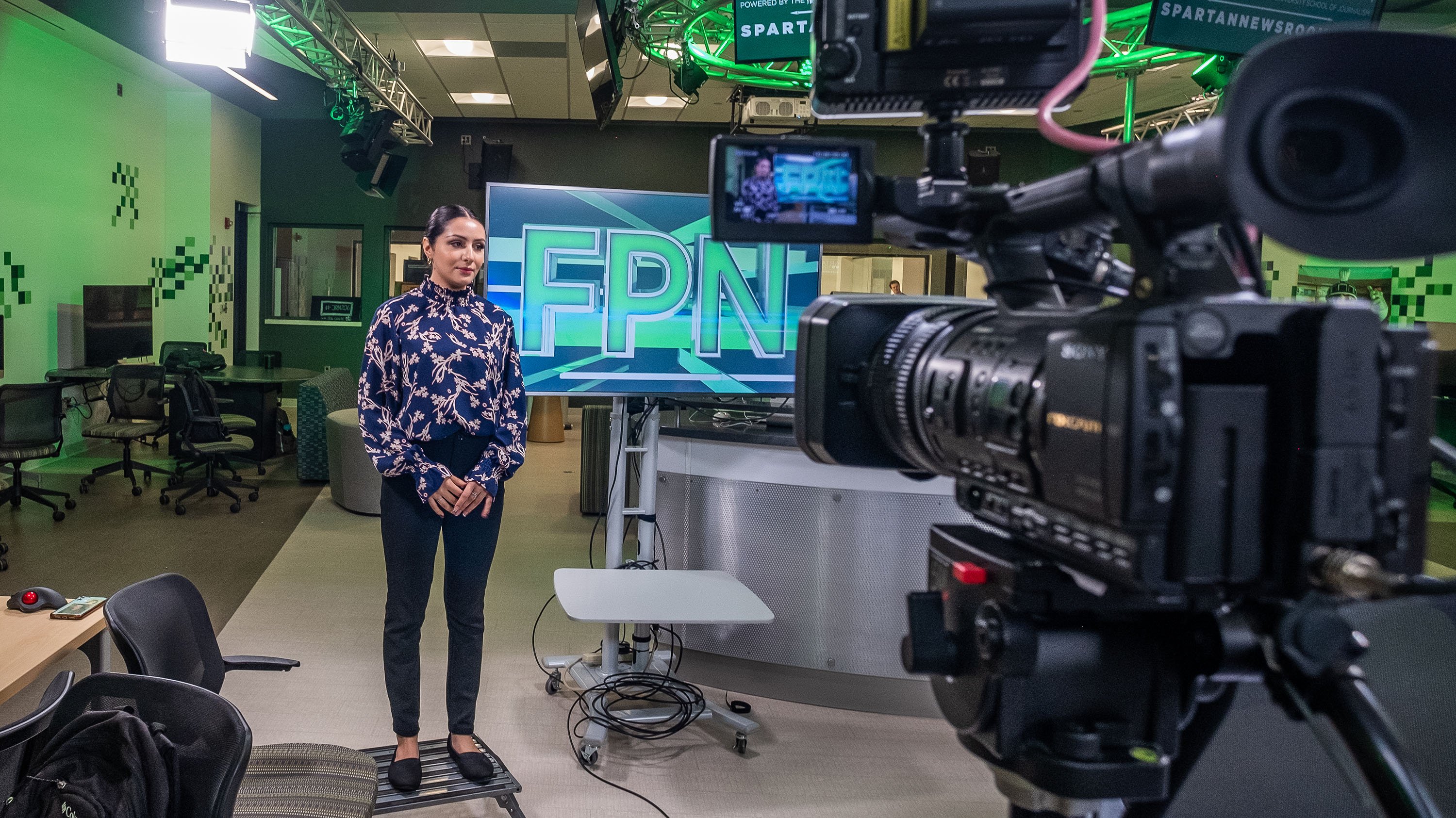 Student in front of camera in the Communications Arts and Sciences building.