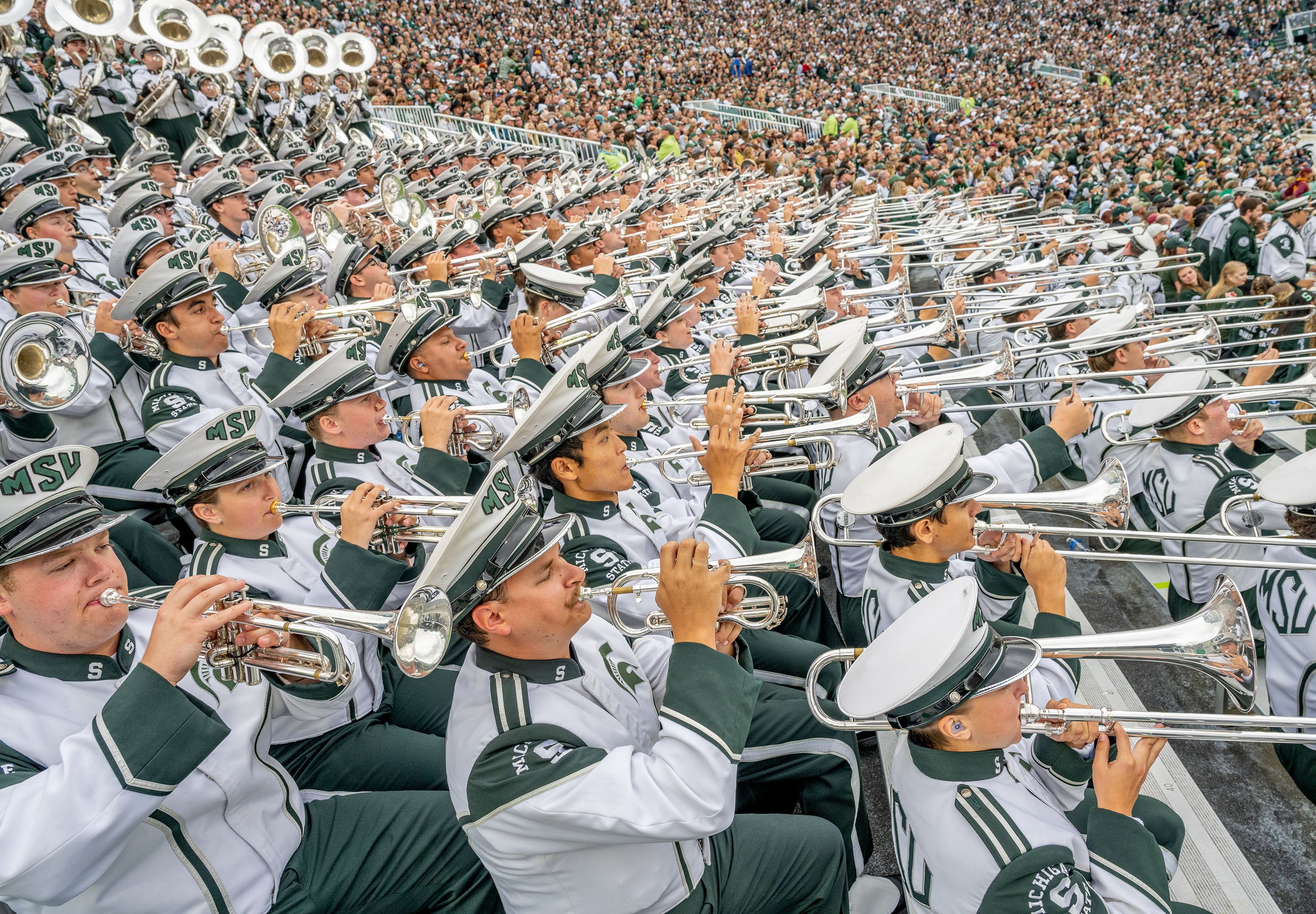 Members of the Spartan Marching Band play during the MSU-University of Minnesota football game at Spartan Stadium.