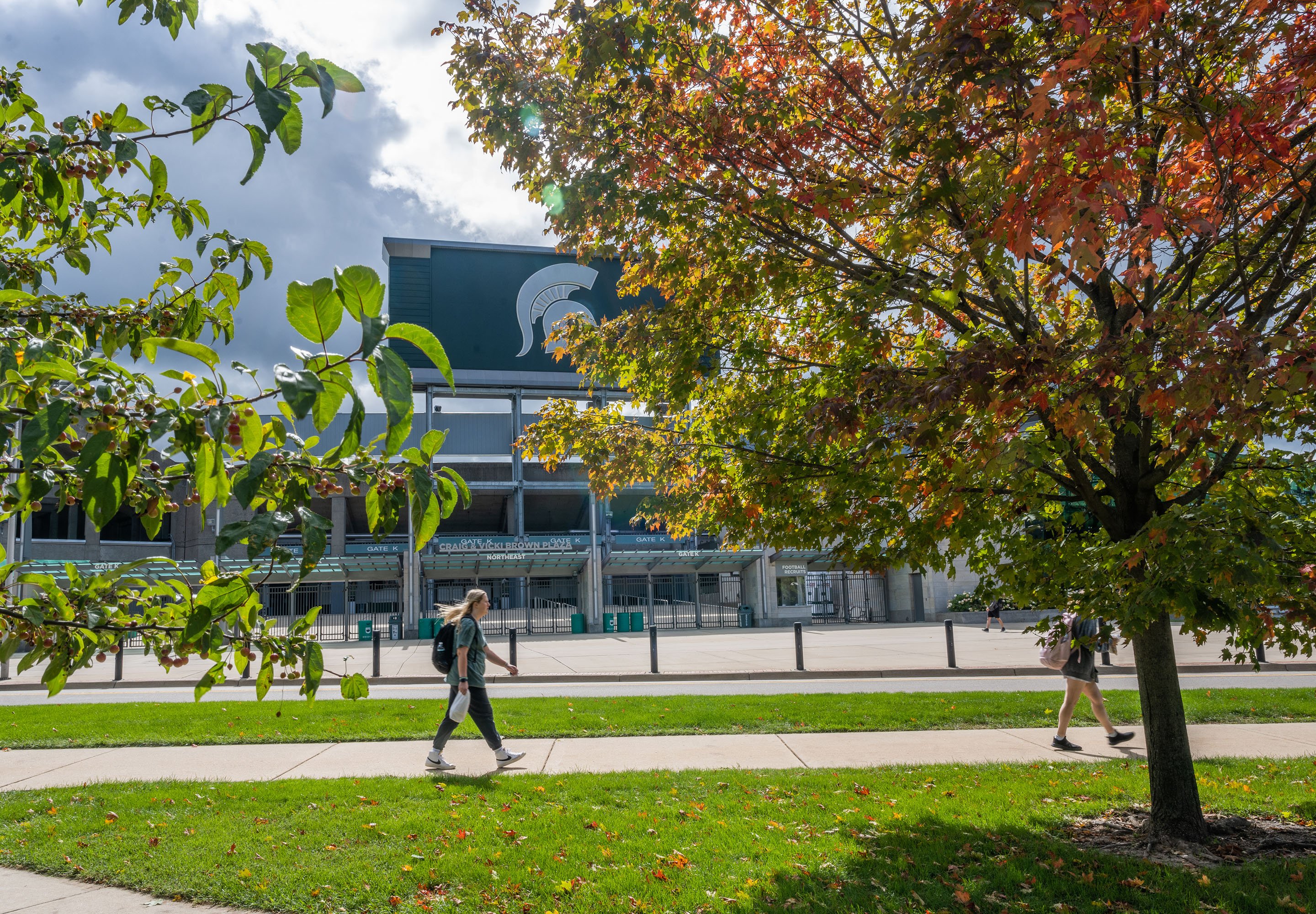 Tree leaves begin to show their fall colors while highlighting Spartan Stadium. Photo by Derrick L. Turner.