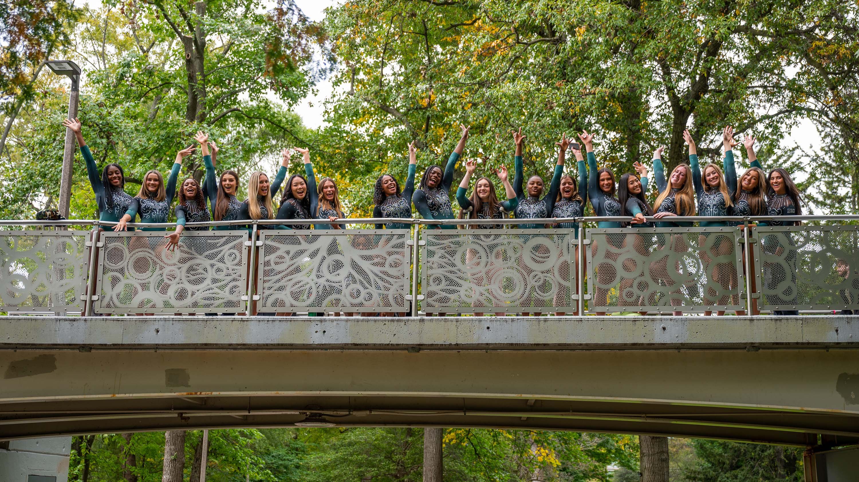 MSU Gymnastics team posing on library bridge
