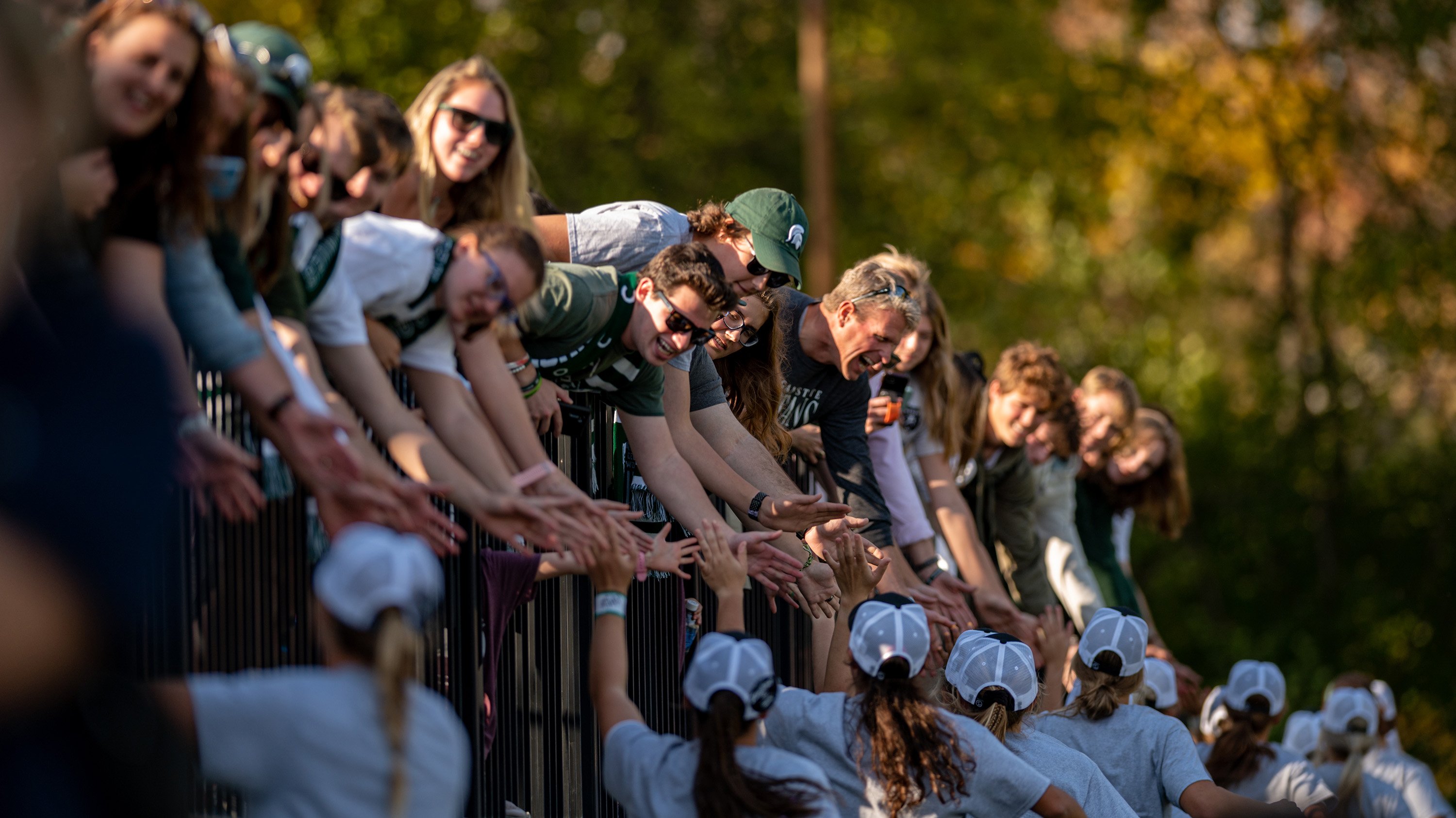 Fans at MSU soccer game high-five team