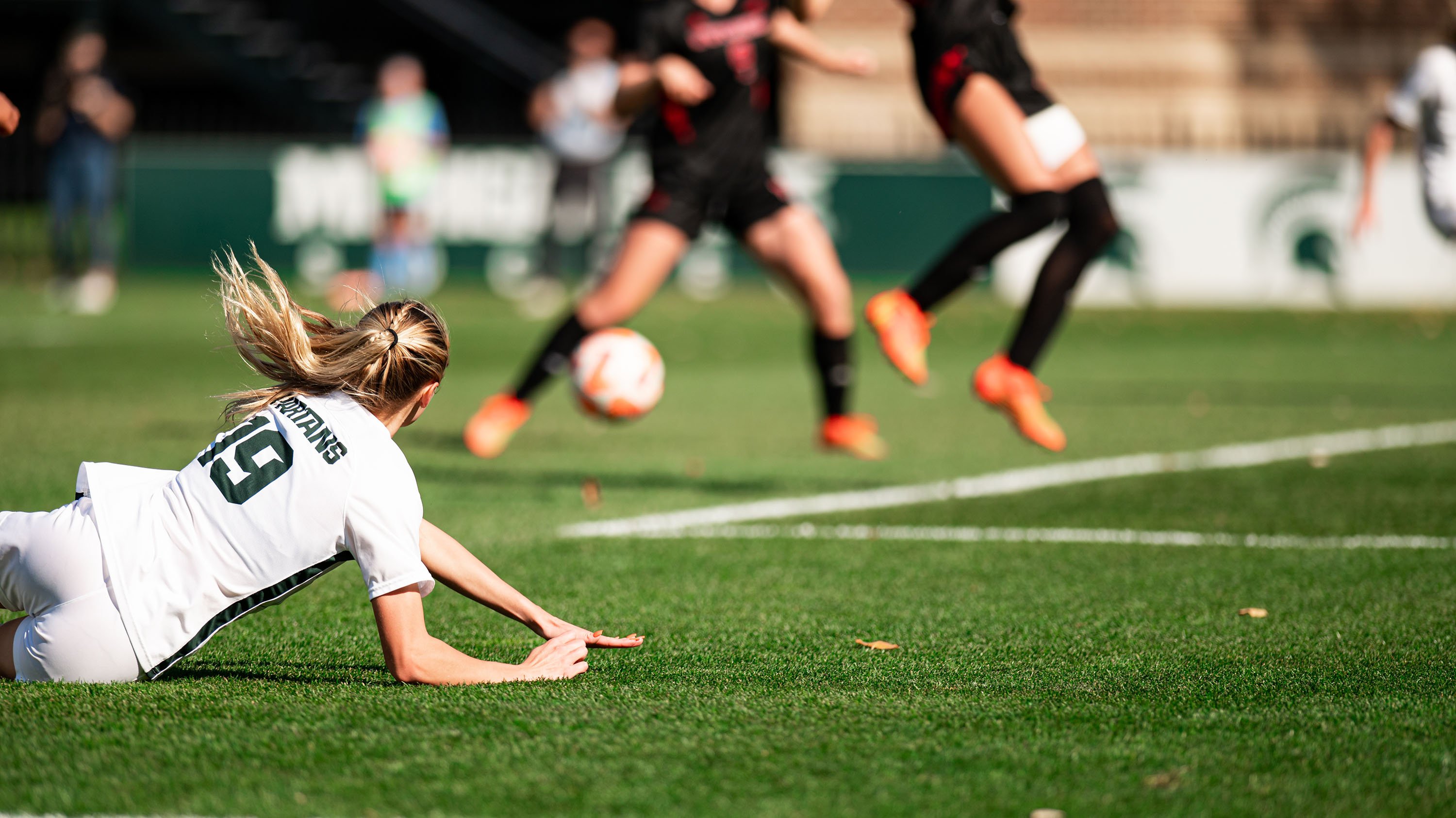 MSU soccer player diving on field