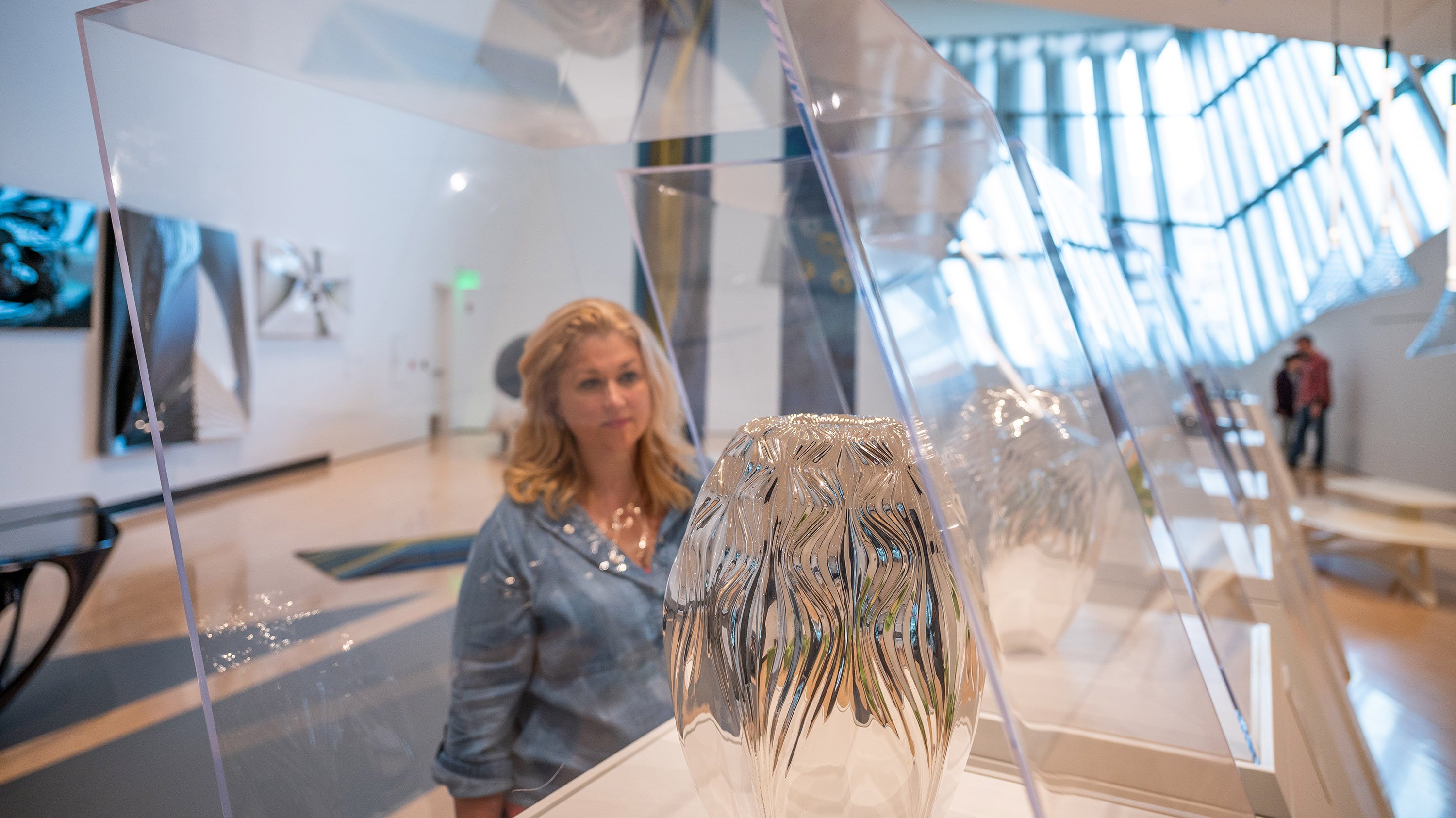 Visitor looking at vases at MSU Broad Museum