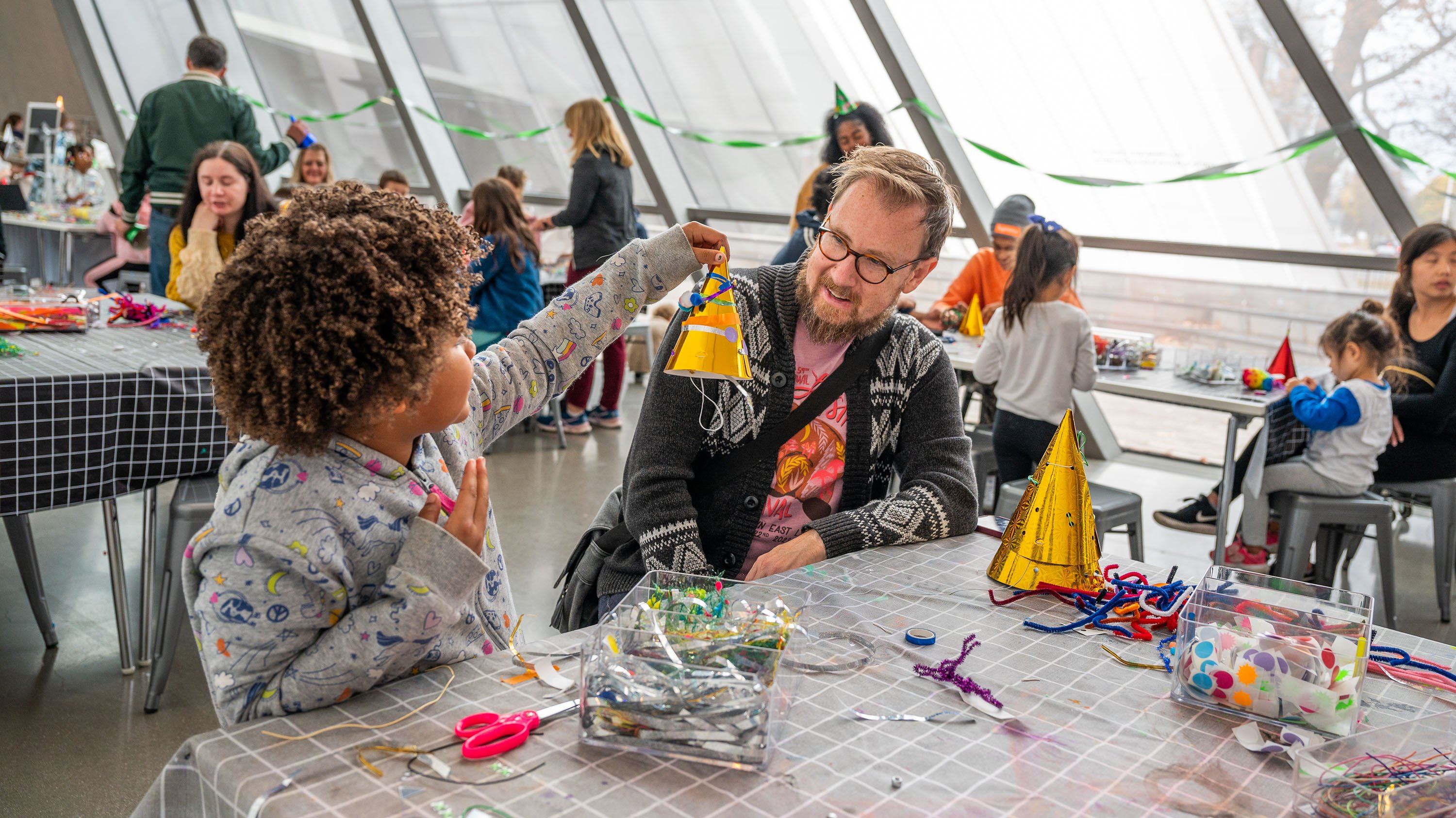 Parent and child making a craft at Family Day