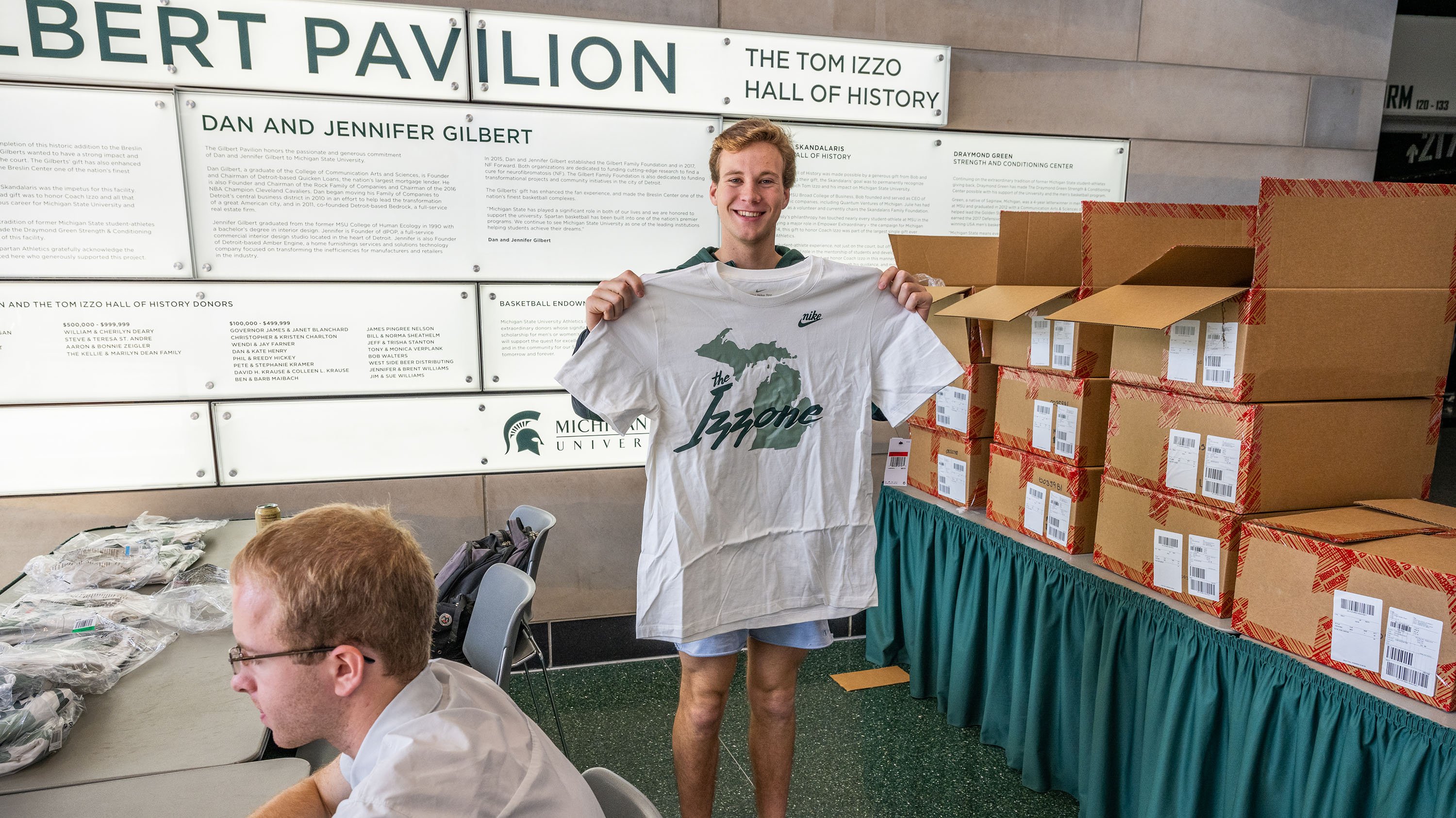 Izzone member holding up T-Shirt