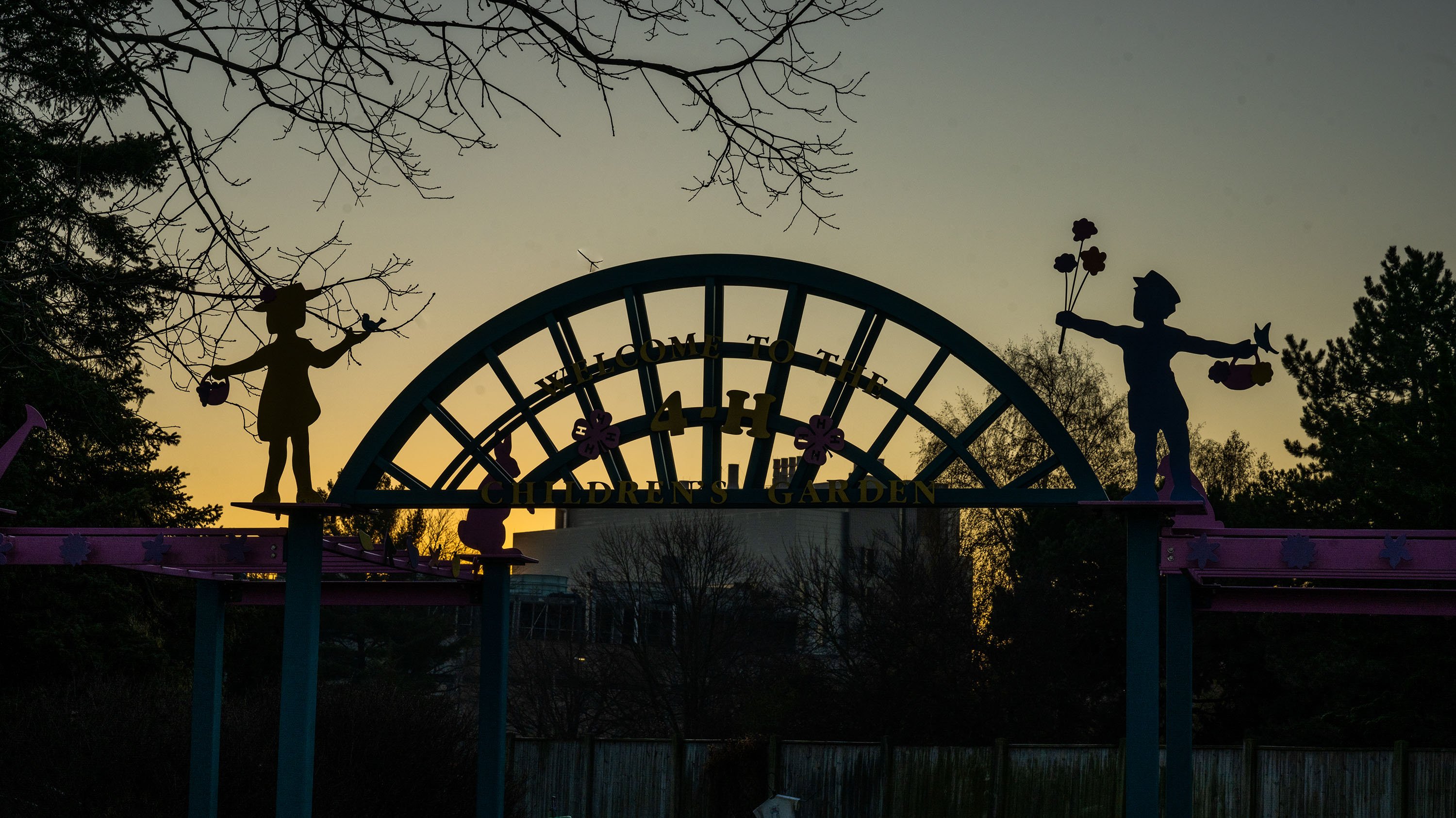 Figures of children on the entrance to 4H gardens at sunrise