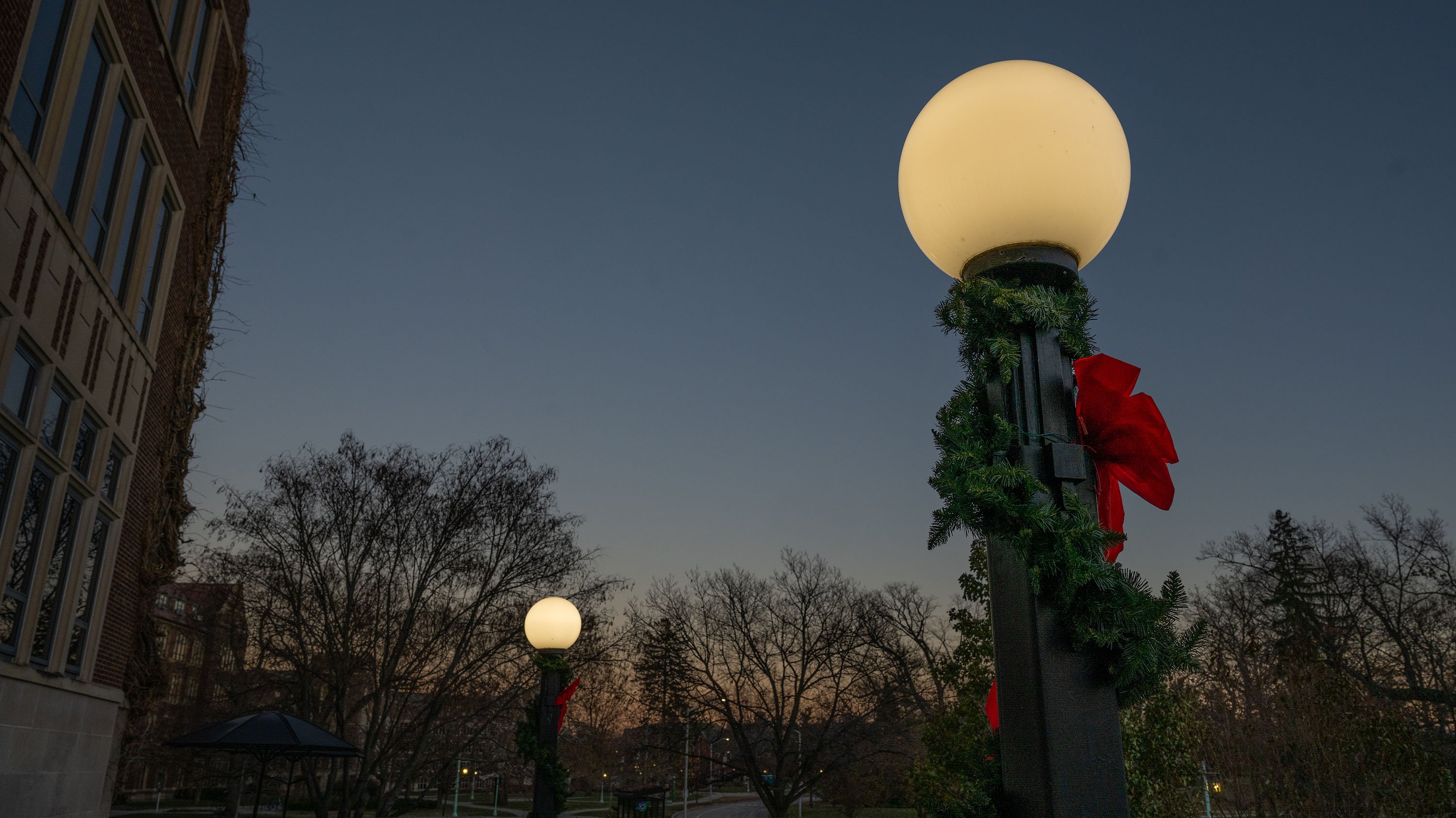 Holiday garlands on the globe lanterns outside the MSU Union