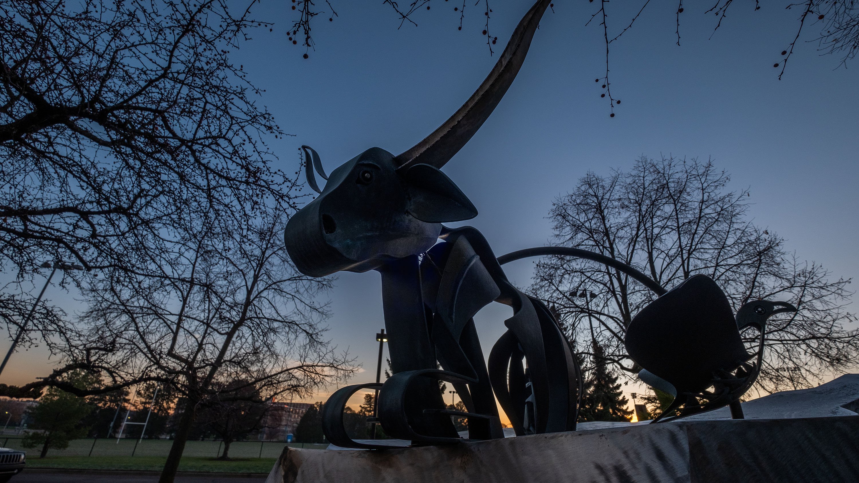 Sunrise and silhouette of the Animals Sculpture by artist Jim Cunningham, 1999, in front of the MSU College of Veterinary Medicine