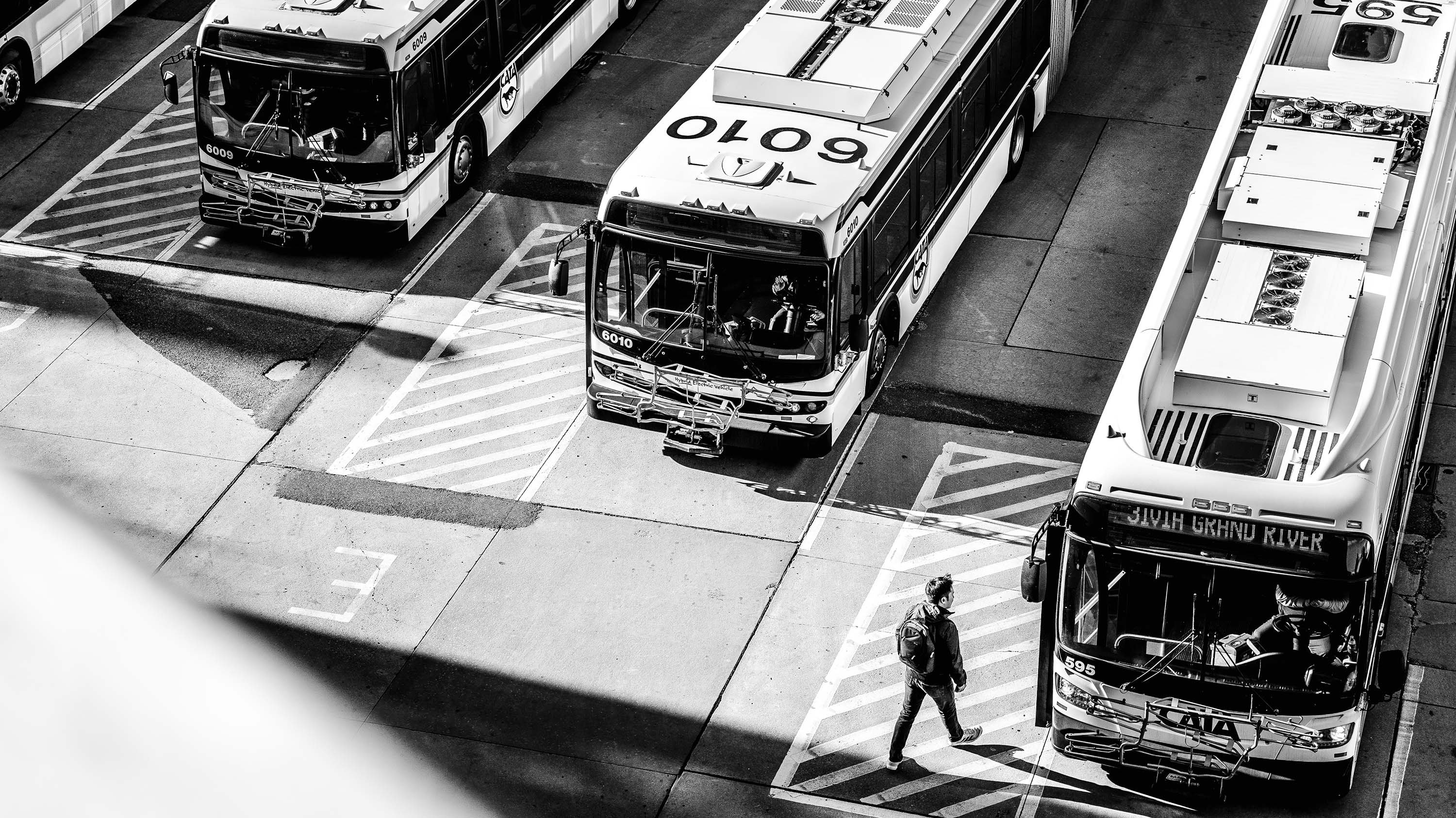An MSU student shuffles to a waiting CATA bus in the center of campus