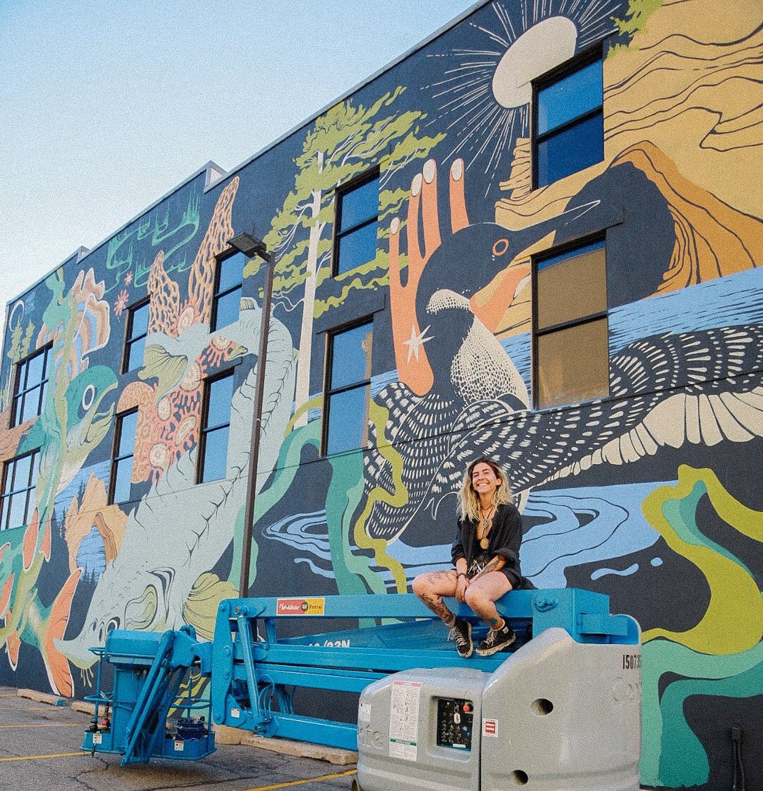 Maddison Chaffer with the completed “Seeking a Pleasant Peninsula” mural. (Photo credit: Jonas Quirin)