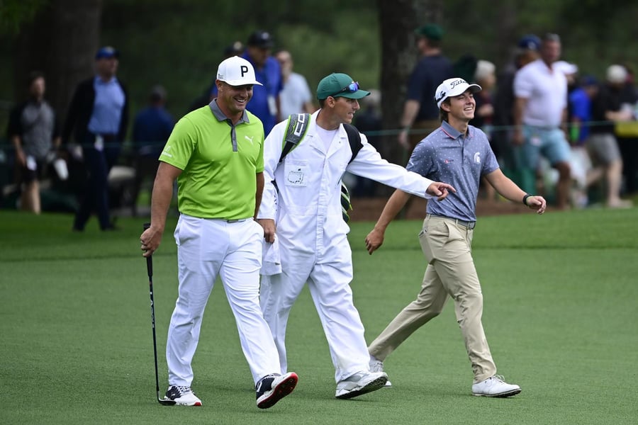 James Piot and Bryson DeChambeau walk down a fairway at The Masters