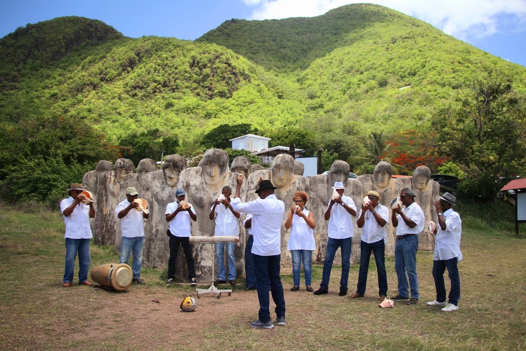 Project partner Watabwi creole group performing conch announcement of ship arrival