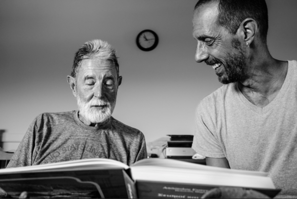 Professor Jon Frey (right) and his predecessor and mentor, Professor Timothy Gregory (left), as they look over a new book they received from a colleague in Greece. 