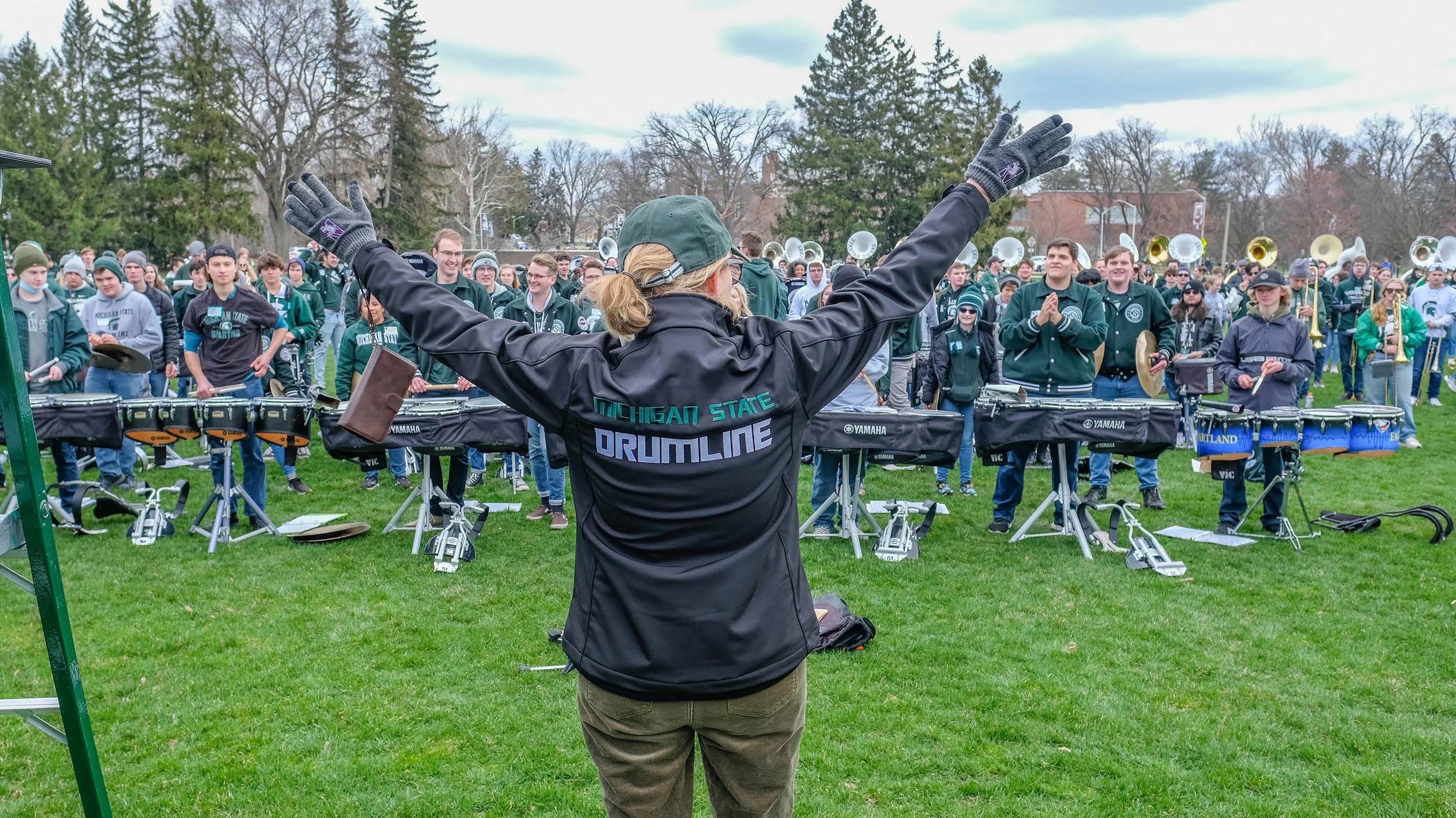 Teresa K. Woodruff visits with the Spartan Marching Band.