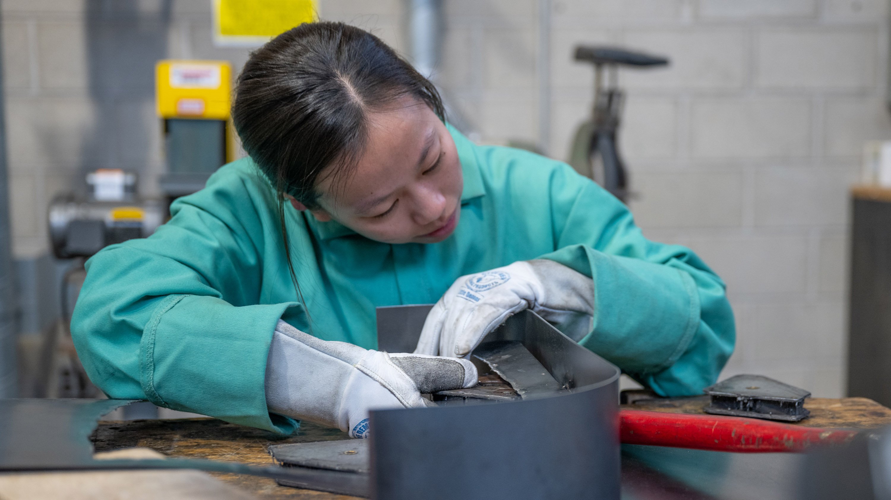 Student working on metal scultpure
