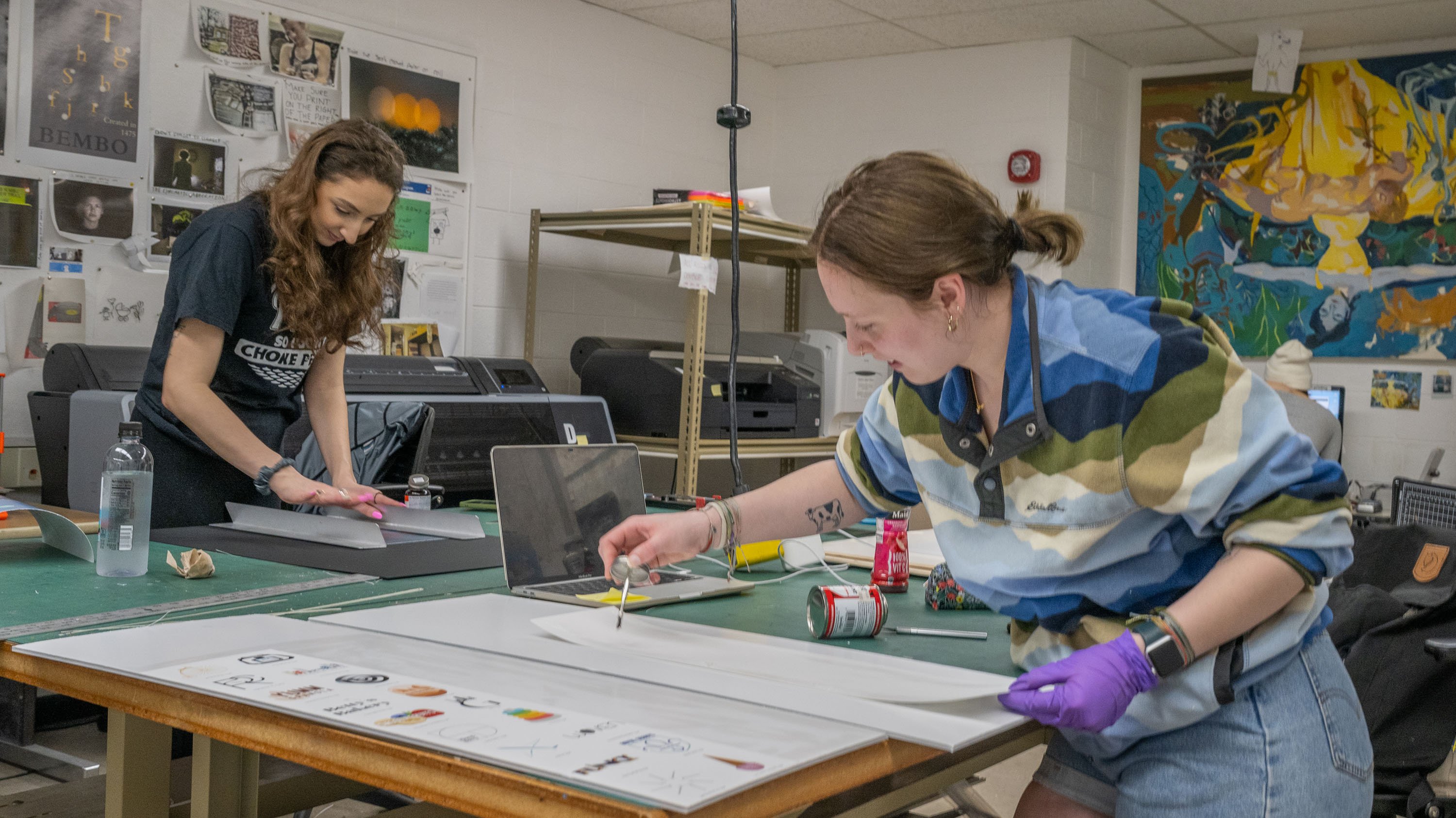 Students. mounting artworks with rubber cement in the print lab