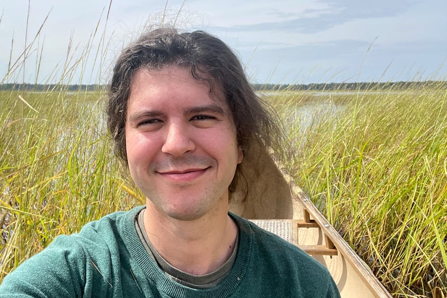 Elan Pochedley harvesting mnomen (wild rice) in eastern Michigan in September 2023.
