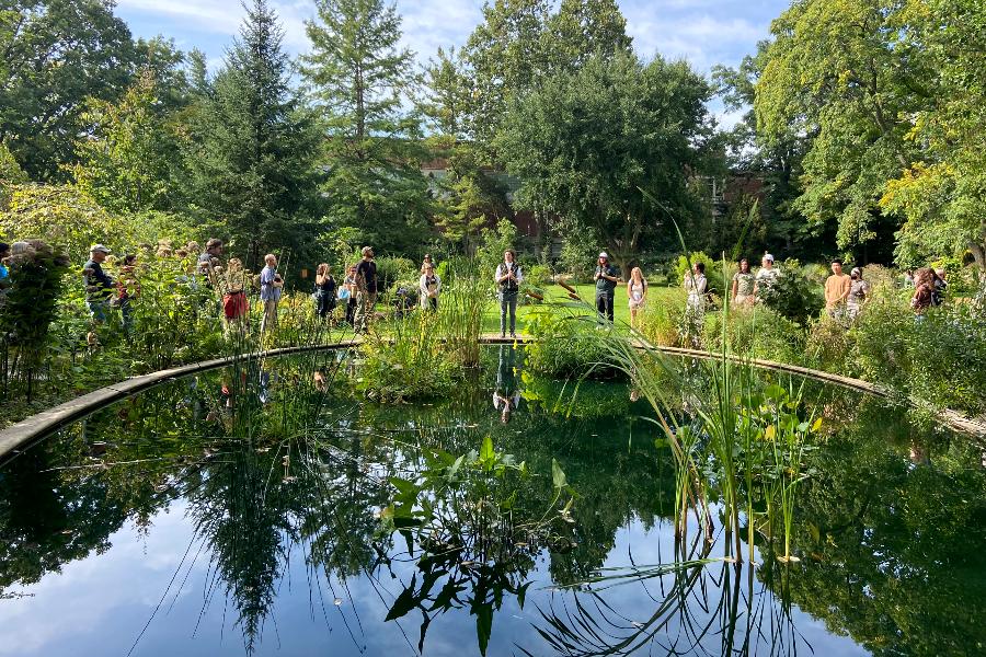 Elan Pochedley (center) at MSU’s Beal Botanical Garden at an event where he was introducing Kaya DeerInWater for his “Neshnabé Ethnobotany” walk, an event that Pochedley helped organize. (Photo by Amy DeRogatis)
