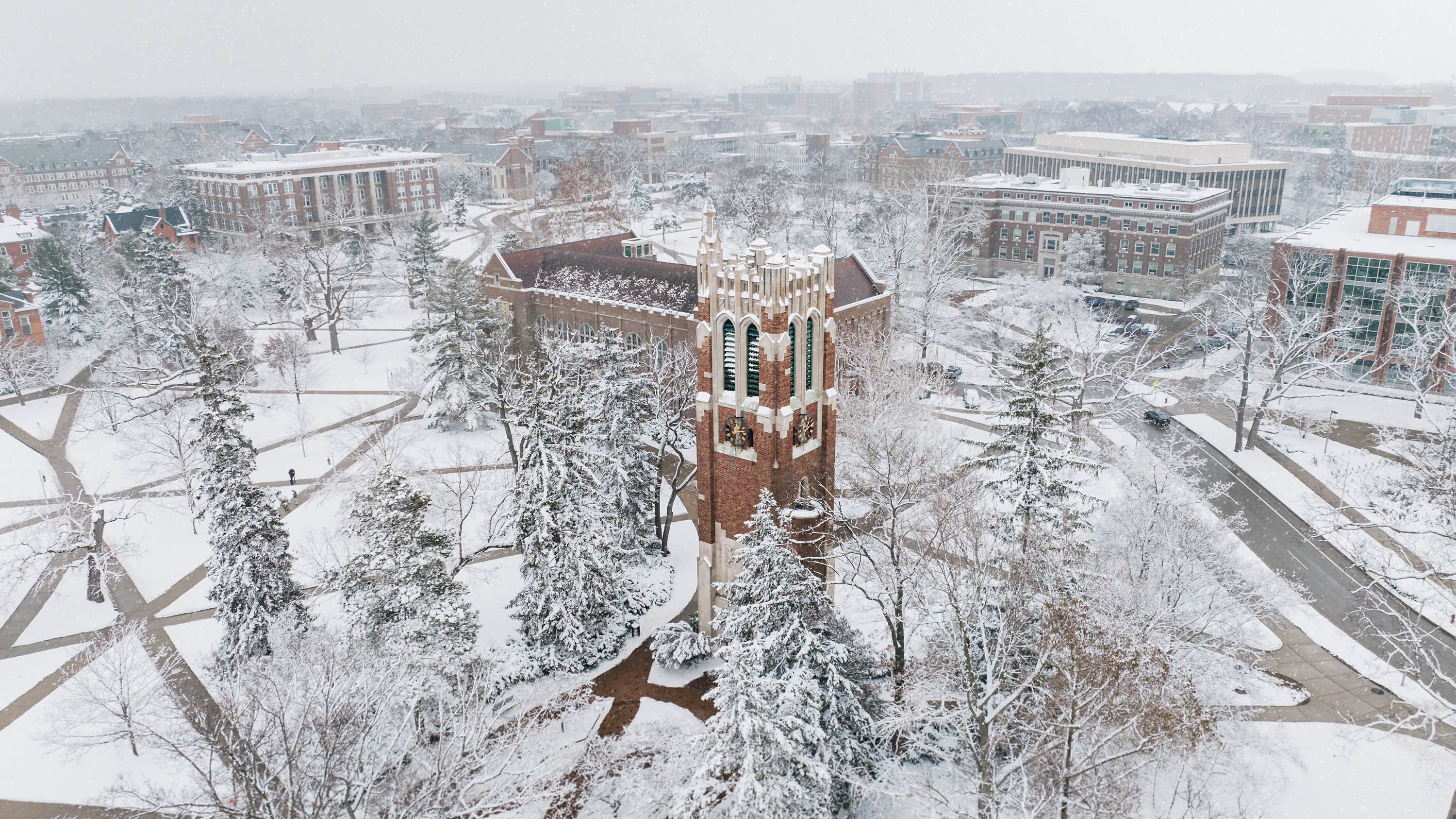 Overhead view of Beaumont Tower and campus during snowfall
