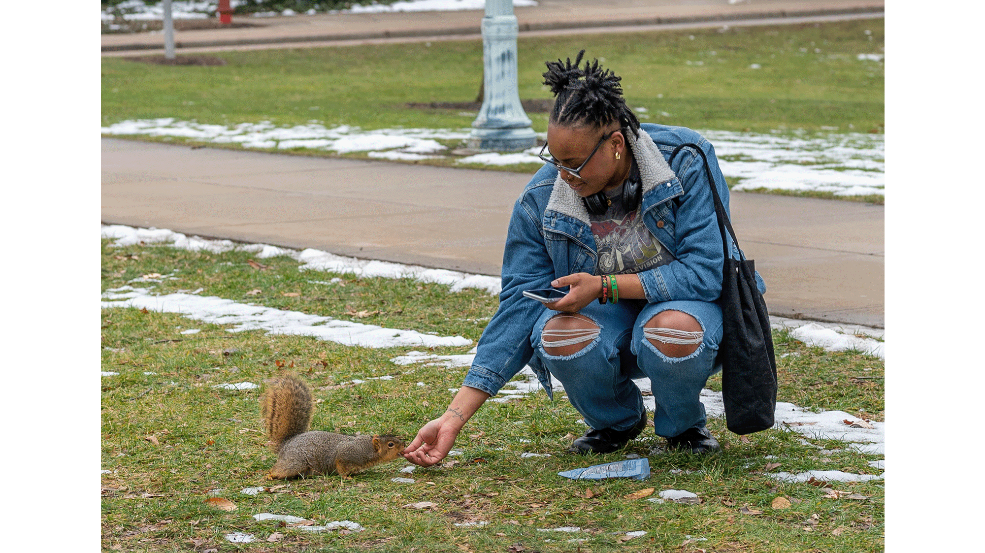 Student feeding squirrel