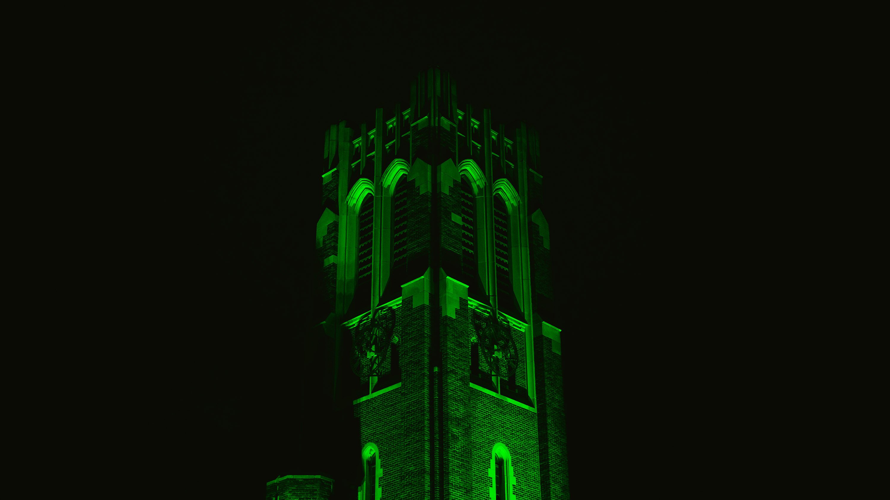 Beaumont Tower illuminated with green light
