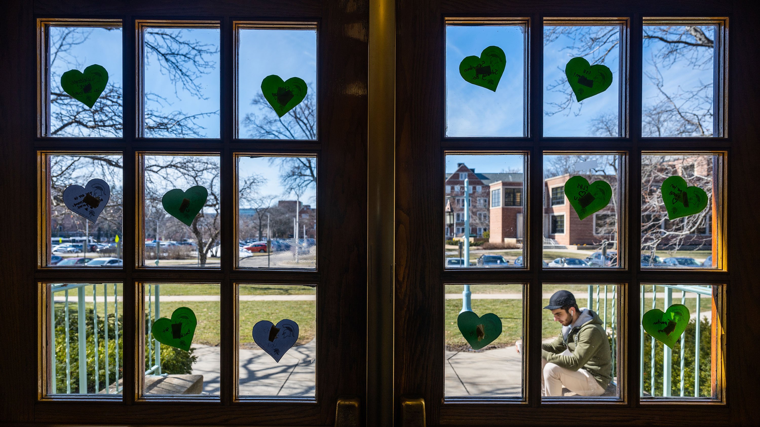 Paper hearts on the windowpanes of the entrance to Snyder-Phillips Hall
