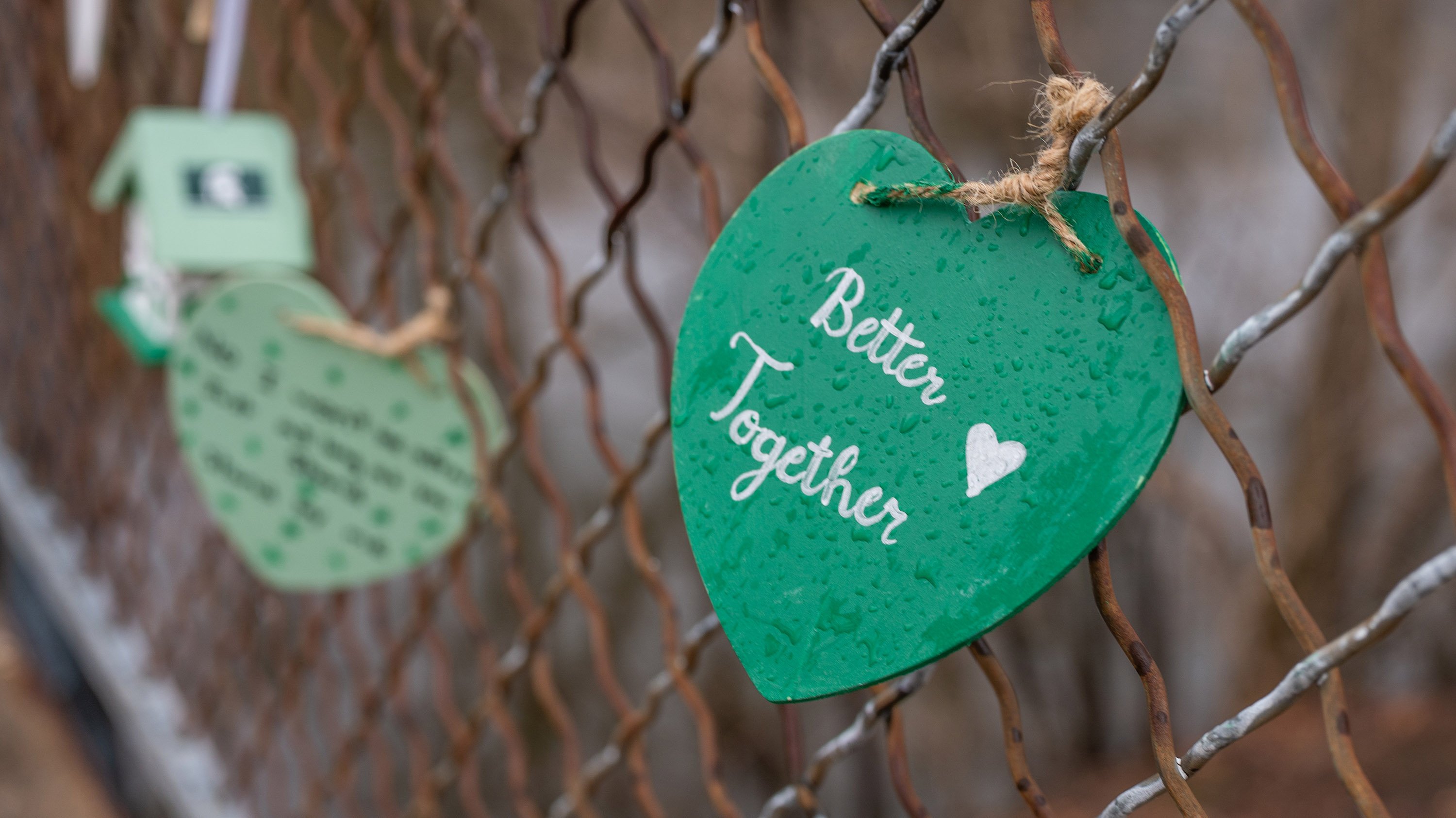 heart tied to bridge with text 'better together' painted on