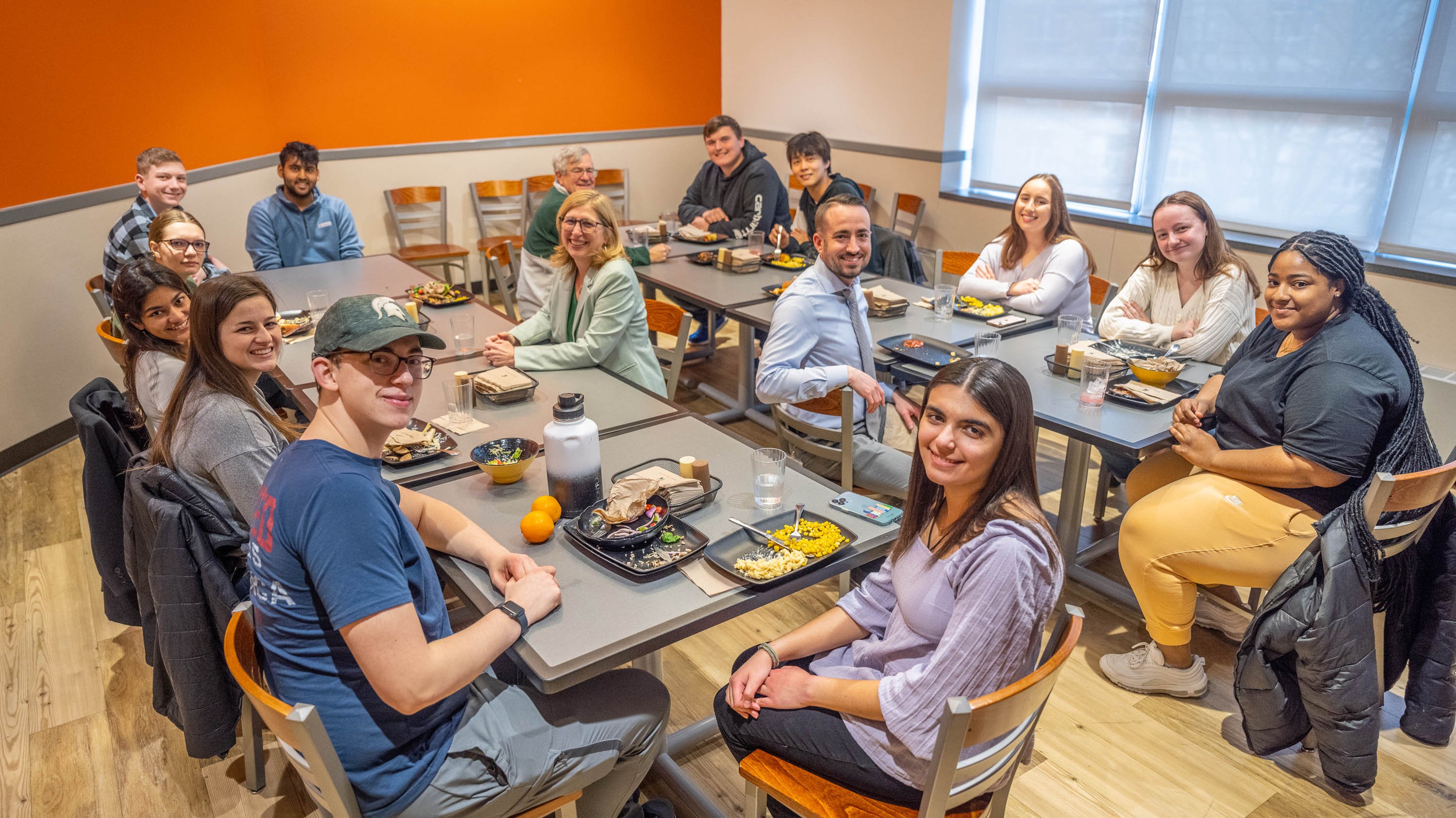 Teresa Woodruff, Tom O'Hallaran and Brandon Gross have dinner with students in Akers Hall.