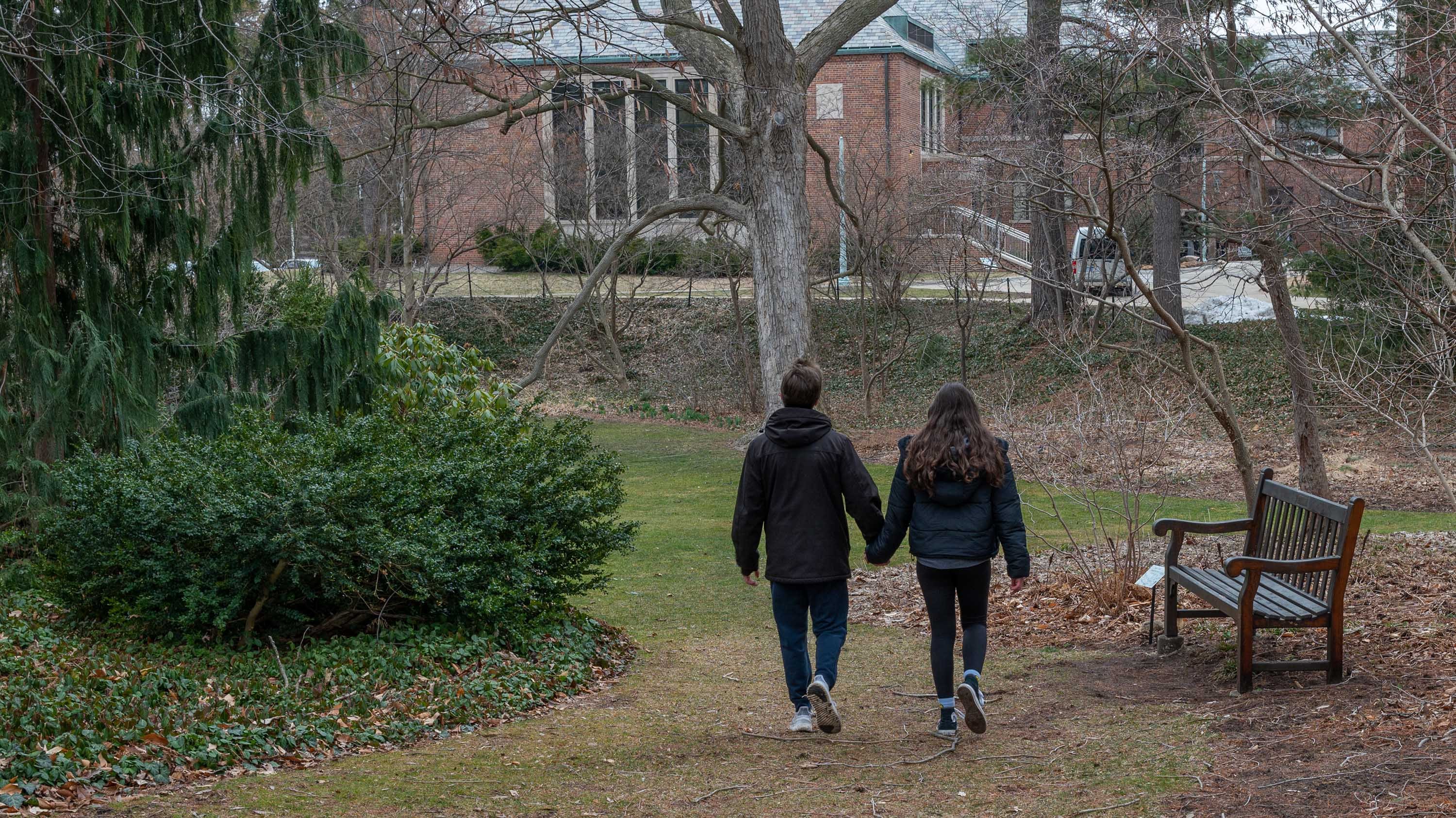 Two people holding hands and walking in Sleepy Hollow