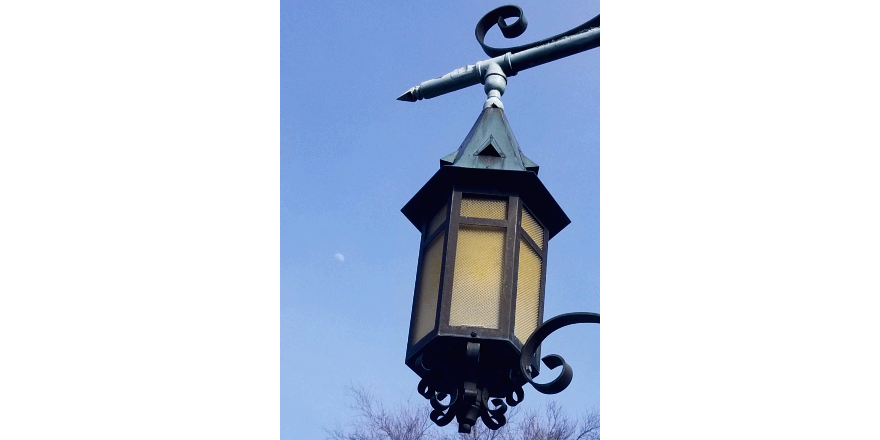 Lantern in front of moon in daytime