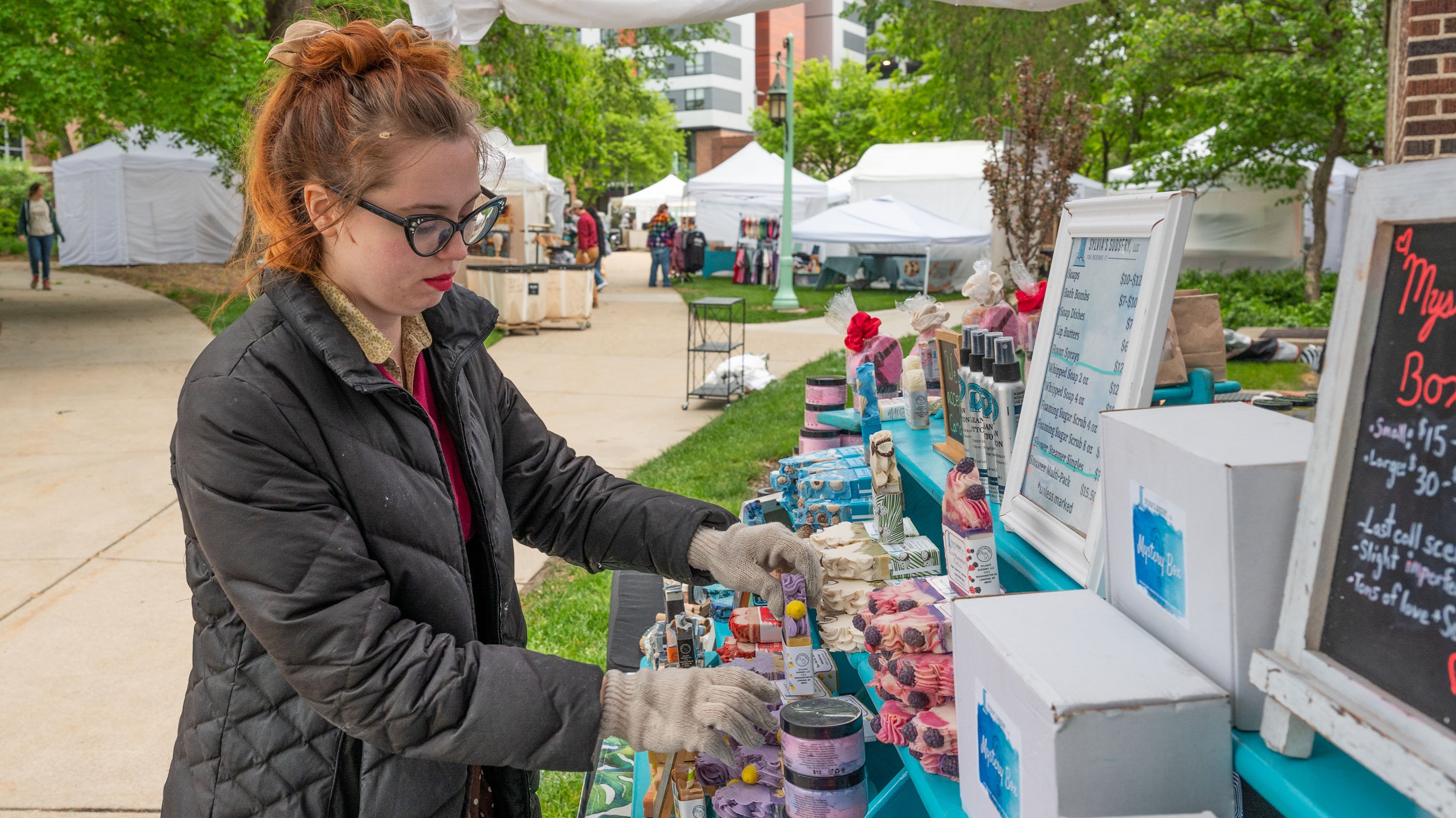 Vendor arranging goods before craft fair