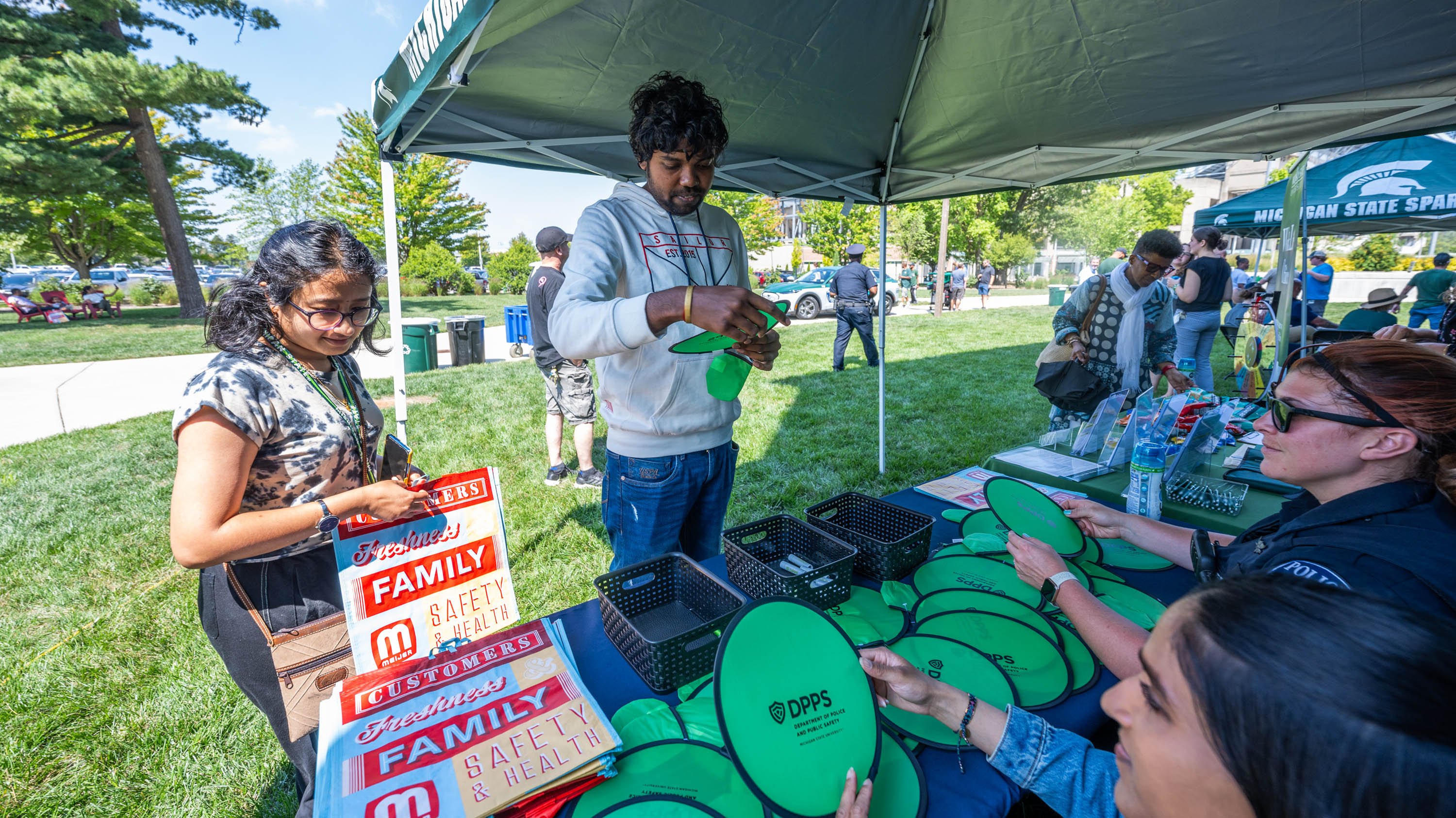 DPPS workers handing out throwing discs at Community Cool Down event