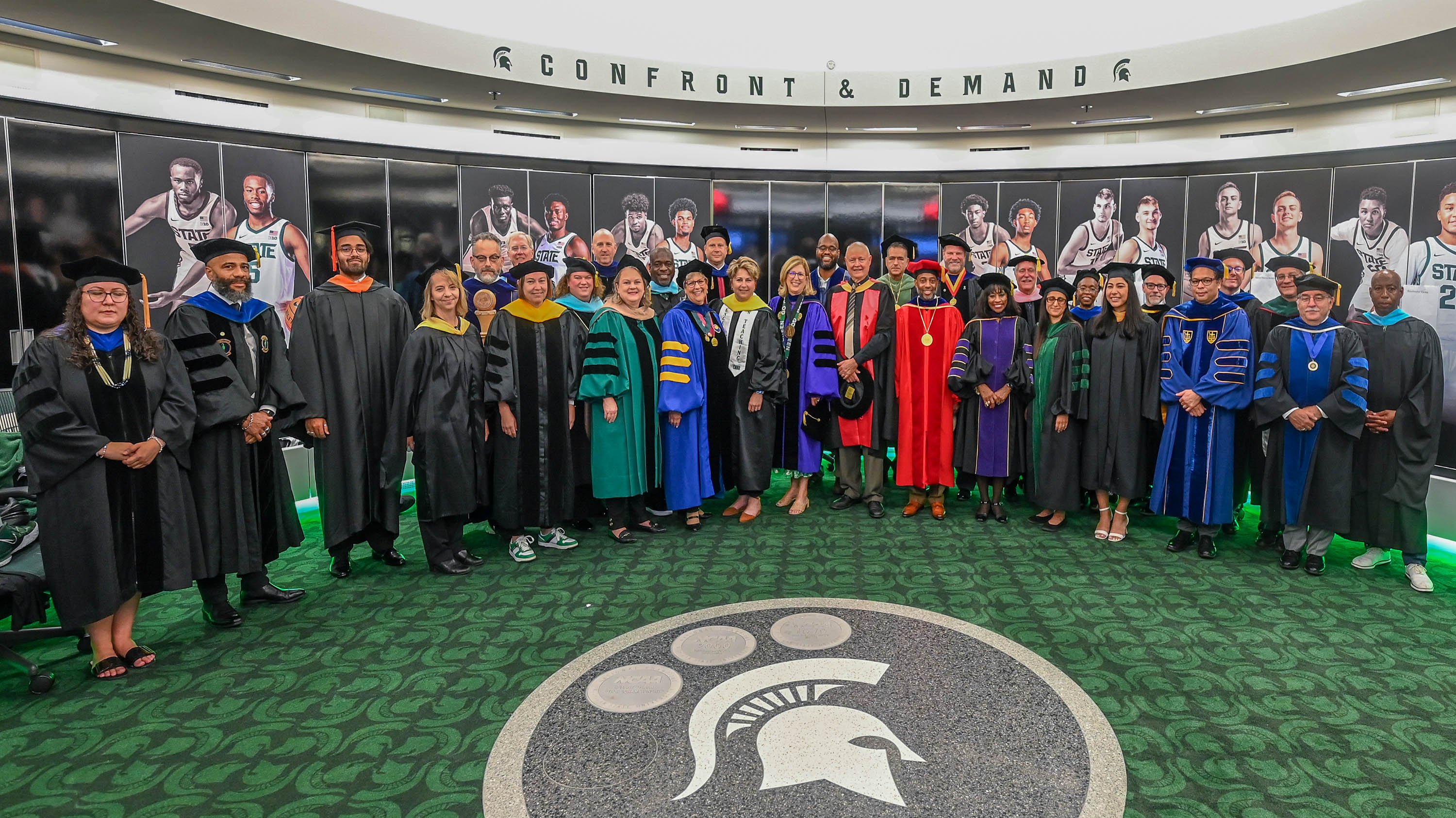 Deans and faculty standing together in Breslin Center